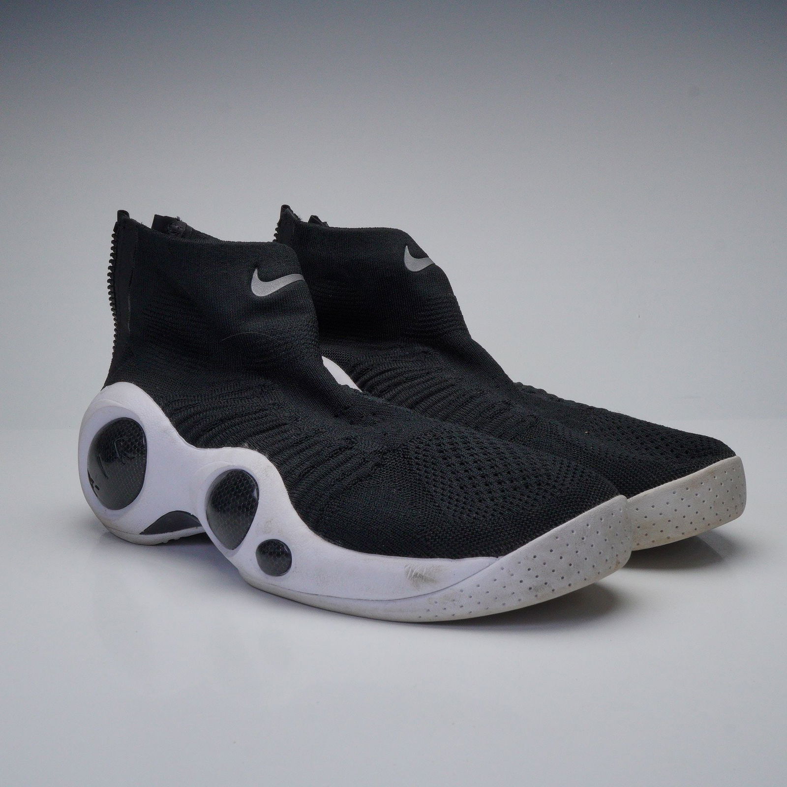 A Pair of Nike Flight Bonafide Black Sneakers, Style No. 917742-001: A pair of Nike Flight Bonafide Black sneakers, style number 917742-001. These modern athletic high-top sneakers feature a black knitted textile sock-like upper and a contrasting white, sculptural rubb