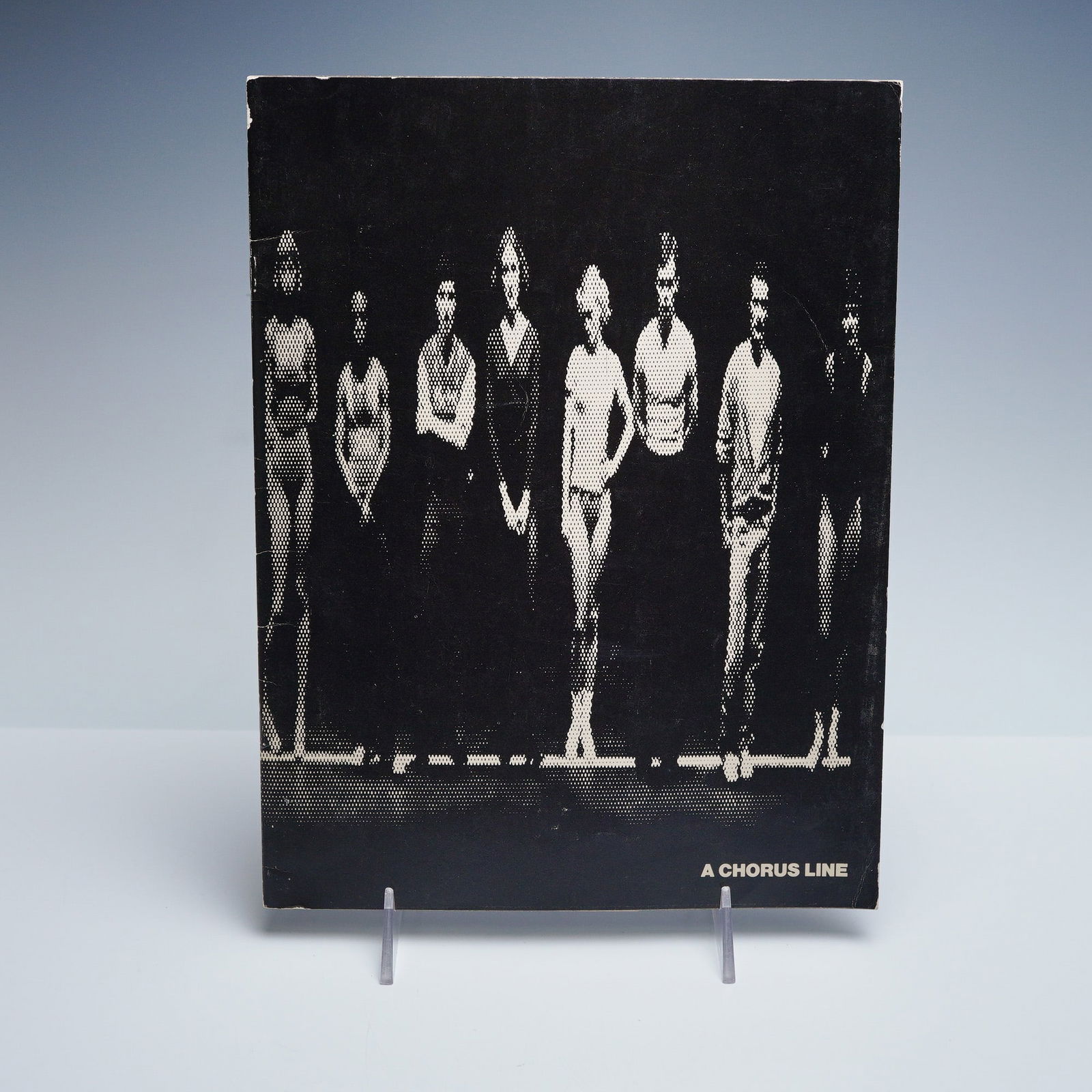 A Chorus Line Souvenir Booklet Theatre Royal: Original souvenir booklet for the 1976 Theatre Royal Drury Lane production of A Chorus Line, presented by Michael White and the New York Shakespeare Festival. Includes cast listings, production