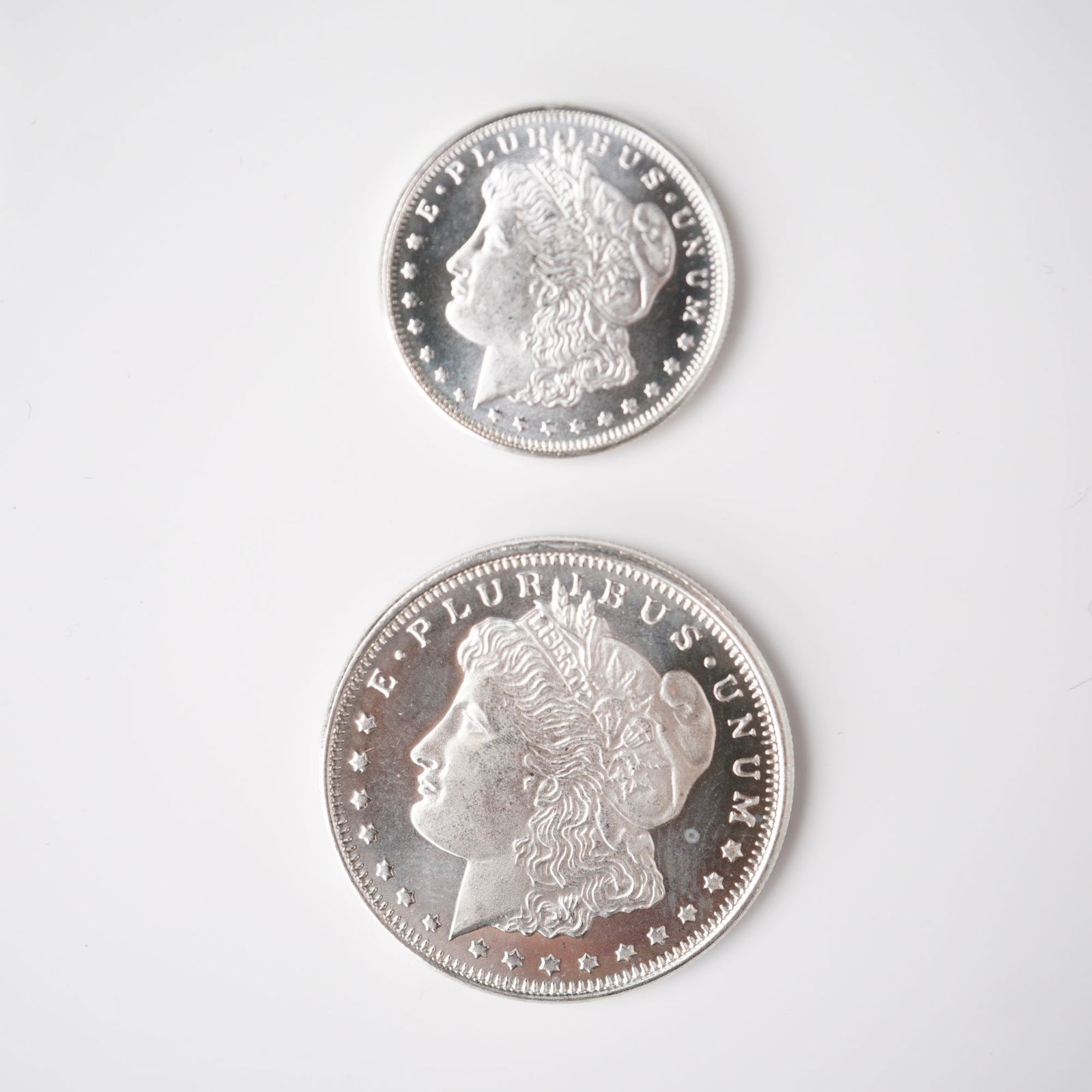 2pc 1/2 Troy Ounce and 1/4 Troy Ounce Morgan Silver Rounds: Two intricately struck silver rounds featuring the classic Morgan Dollar design, each crafted from .999 fine silver and presented in fractional sizes of one-quarter troy ounce and one-half troy