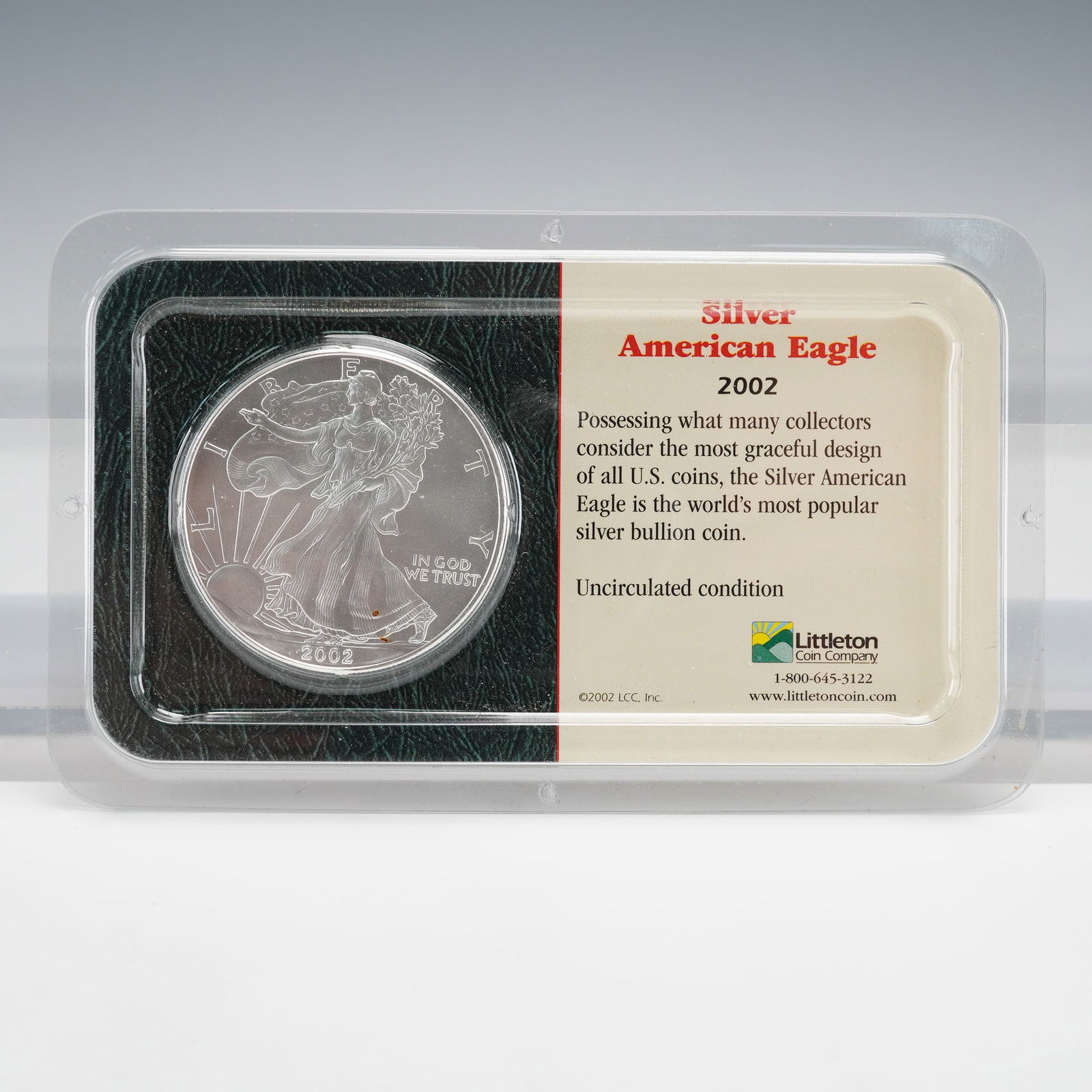 2002 American Silver Eagle 1 oz Bullion, Littleton: A 2002 American Silver Eagle 1 oz bullion coin in a clear SurePak retail holder from Littleton. Obverse: Liberty Walking, dated 2002 with IN GOD WE TRUST. Reverse: Heraldic Eagle, UNITED STATES OF