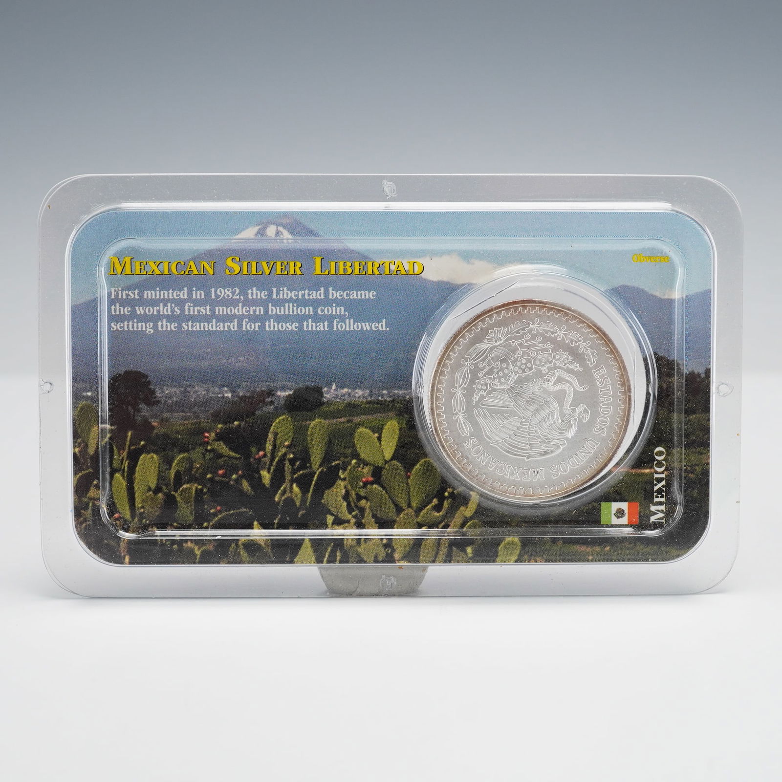 1993 Mexico Silver Libertad 1 Onza in Littleton Package: A 1993 Mexican Silver Libertad 1 Onza bullion coin, 99.9% pure silver. Obverse: Mexican National Seal with eagle and snake, ESTADOS UNIDOS MEXICANOS. Reverse: Winged Victory, 1 ONZA PLATA PURA 1999,