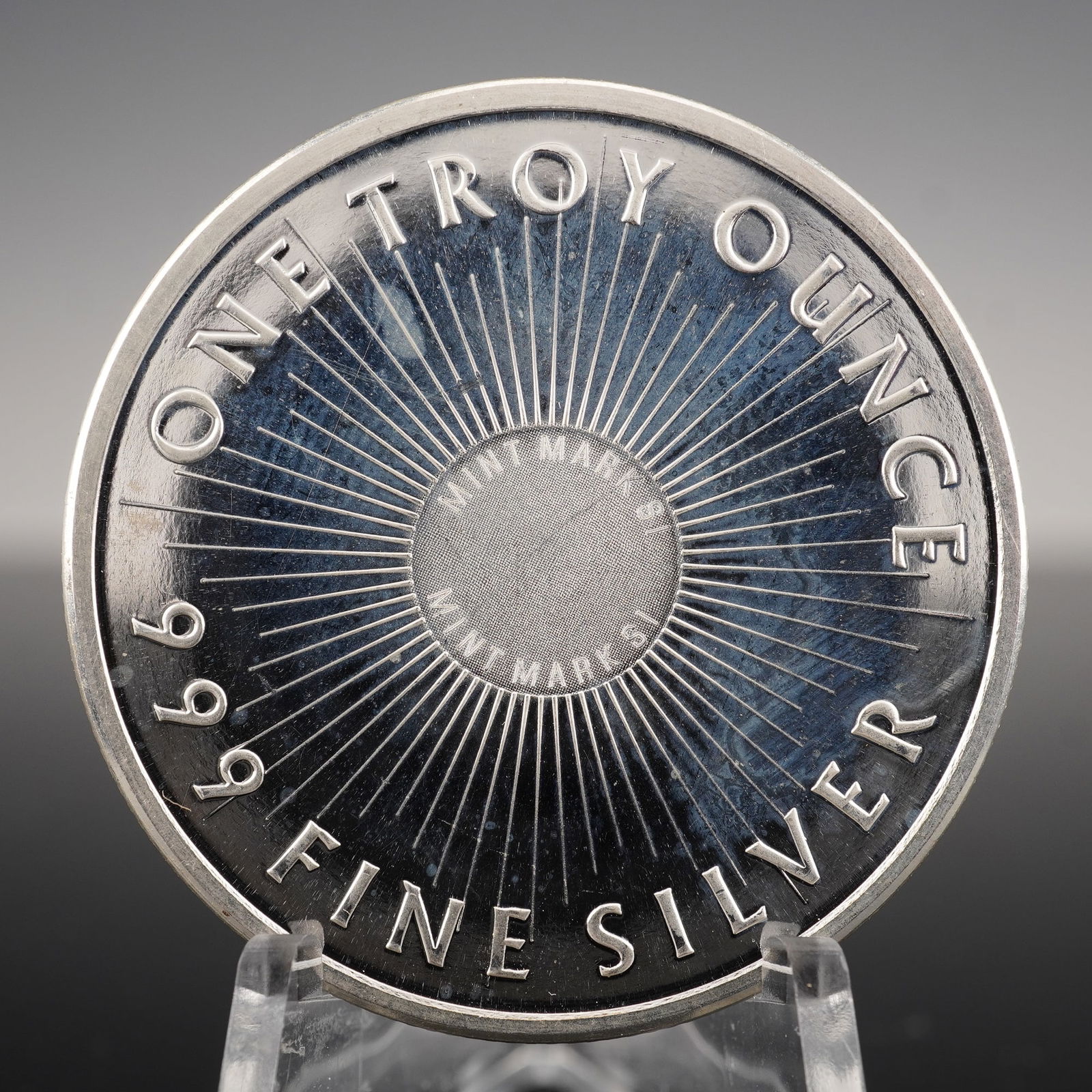 Sunshine Minting One Troy Ounce .999 Fine Silver Round: Sunshine Minting One Troy Ounce .999 Fine Silver Round Mint Mark SI. This silver round is composed of .999 fine silver and weighs one troy ounce. One side features the Sunshine Minting logo with a