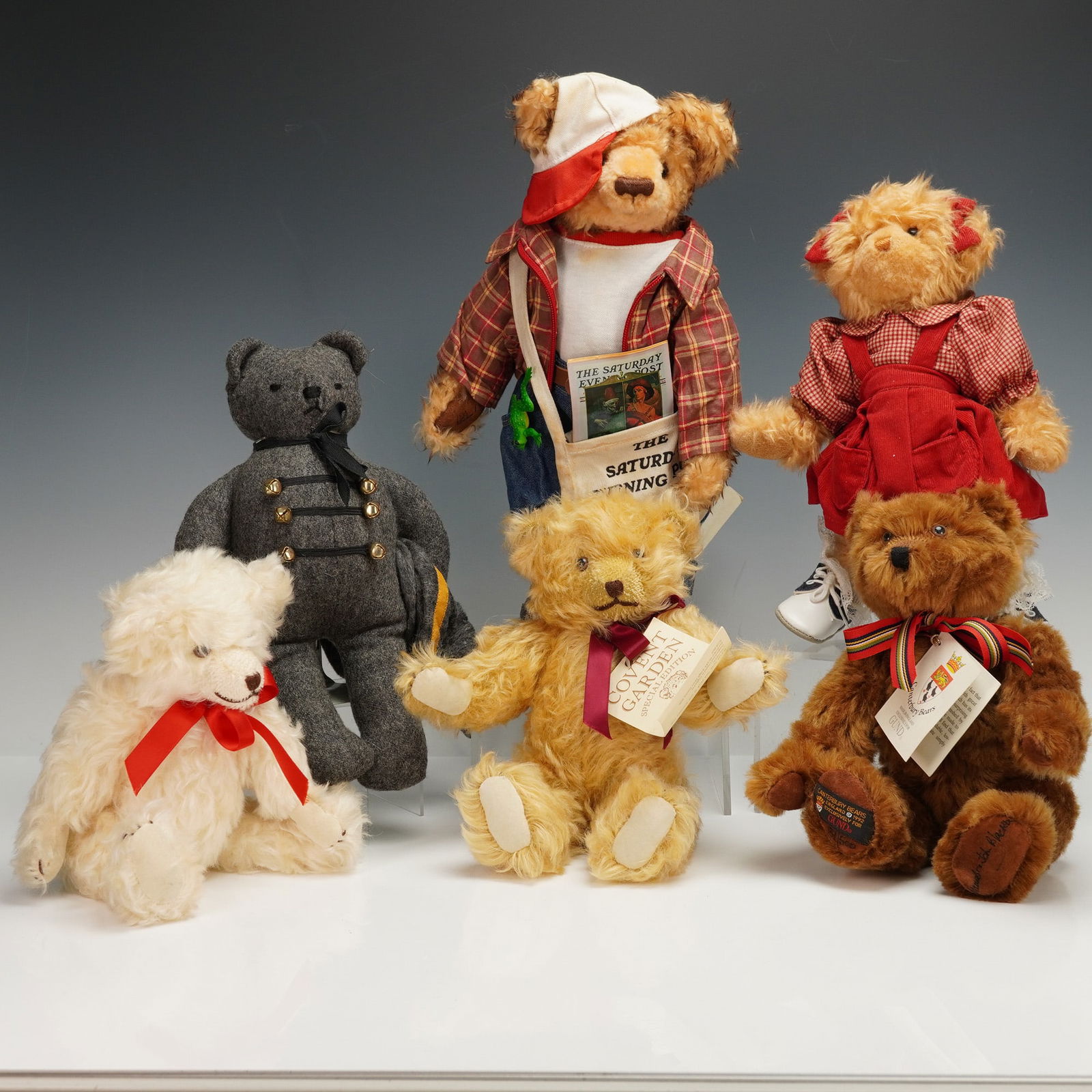 6pc Covent Garden, Douglas Company, & Canterbury Bears Teddy Bears: A group of six teddy bears that includes two Covent Gardens bears in blonde and dirty blonde with curly fur and stitched details, one black felt bear with simple stitched features and brass buttons, o