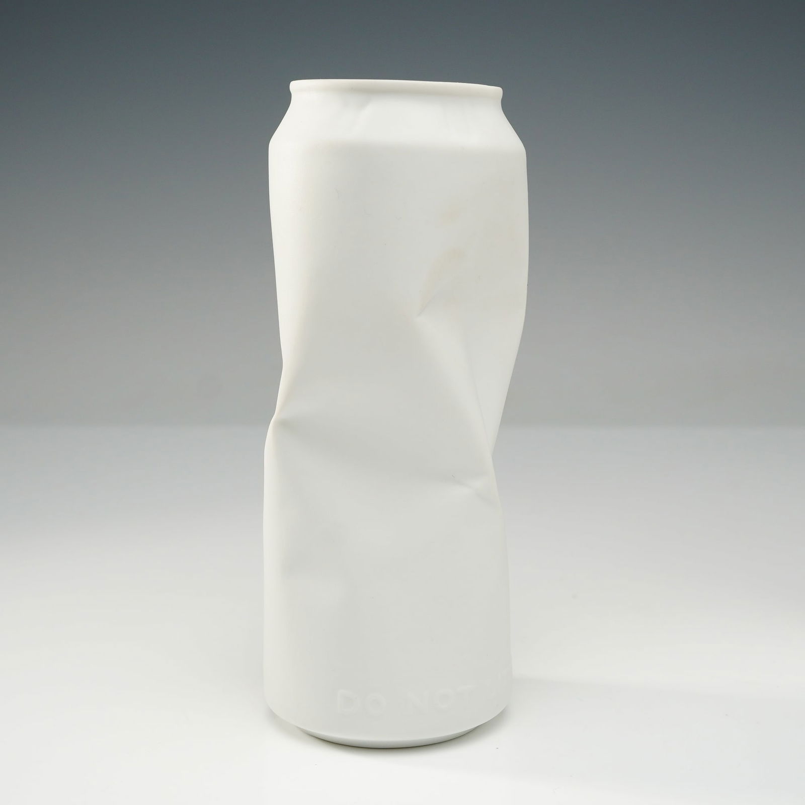 Rosenthal Do Not Litter Collection Bisque Porcelain Crushed Can Vase: A sculptural object from the Rosenthal Do Not Litter collection, executed in matte white bisque porcelain. The piece is cast in the form of a standard-sized beverage can that has been intentionally cr
