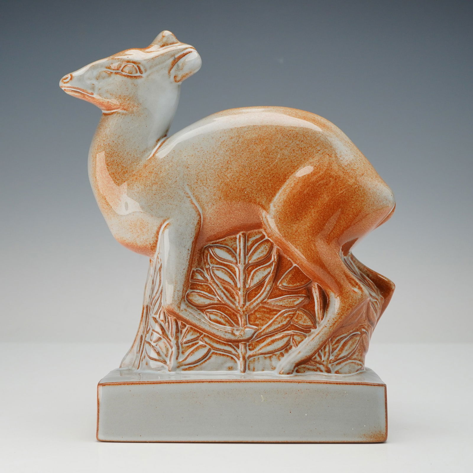 Wedgwood by John Skeaping Brown and Gray Glaze Art Deco Deer Figurine: A Wedgwood ceramic sculpture designed by John Skeaping, depicting a stylized standing deer in an Art Deco idiom. The figure is finished in a mottled reddish-brown and orange glaze over a pale grey to