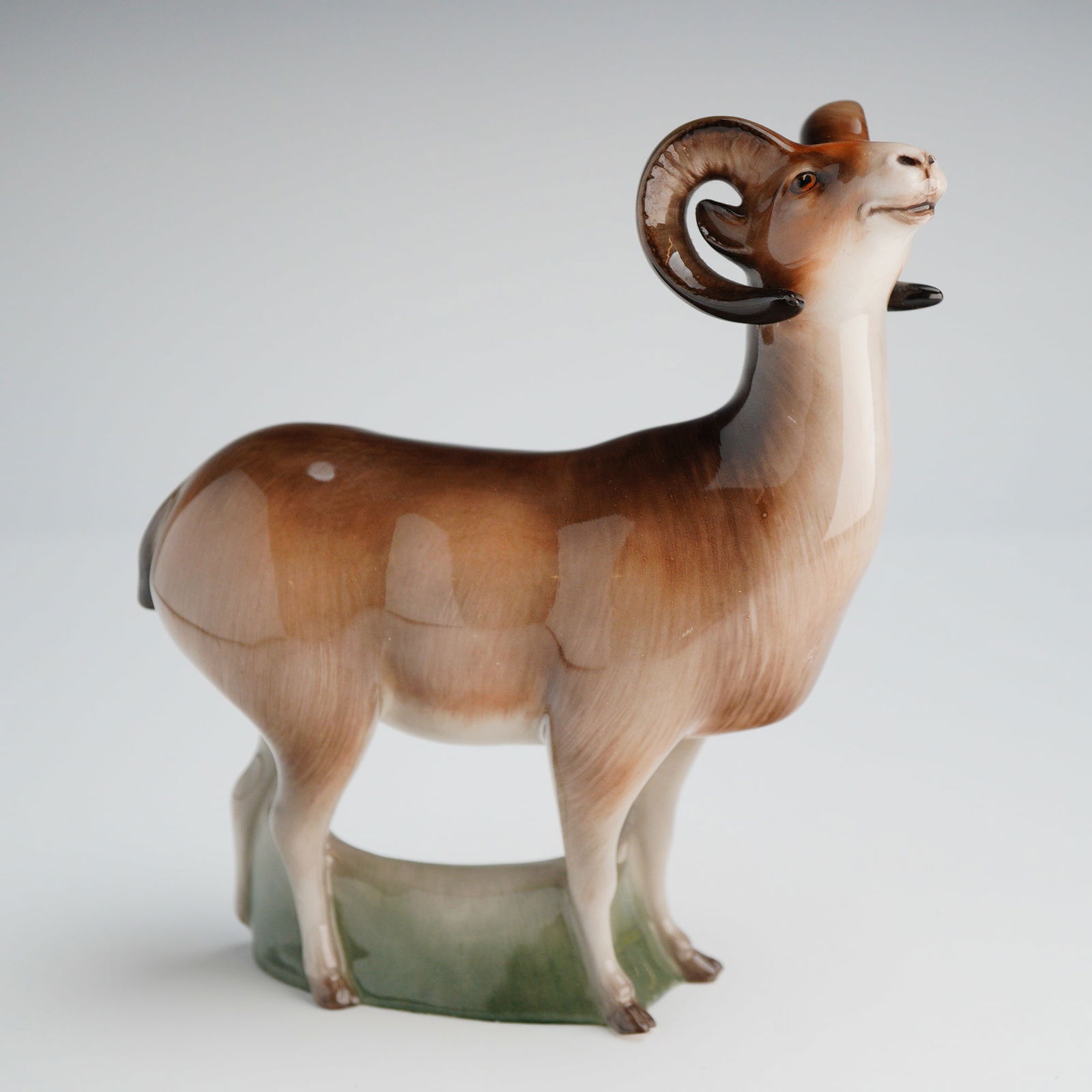 Royal Doulton Mountain Sheep HN2661 Figurine: A single glazed polychrome Bone China figurine identified through factory marks and market consensus as the Royal Doulton 'Mountain Sheep' model, HN2661. The realistically modeled ram or bighorn