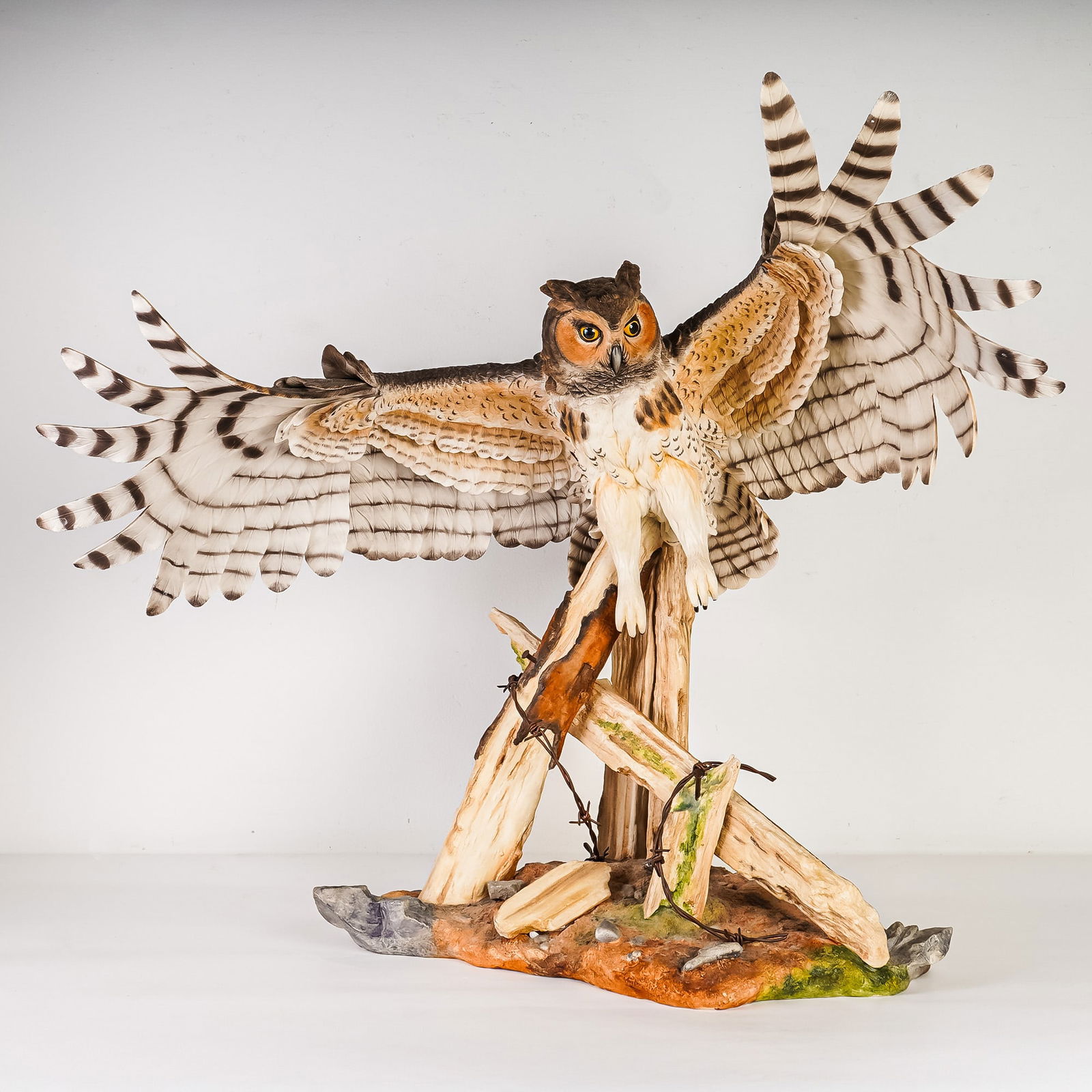 Boehm Large Porcelain Sculpture, Great Horned Owl, Signed: This exceptional Boehm porcelain sculpture depicts a Great Horned Owl (Bubo Virginianus) shown with fully outstretched wings as it lands on a naturalistic base composed of hand-painted porcelain logs,