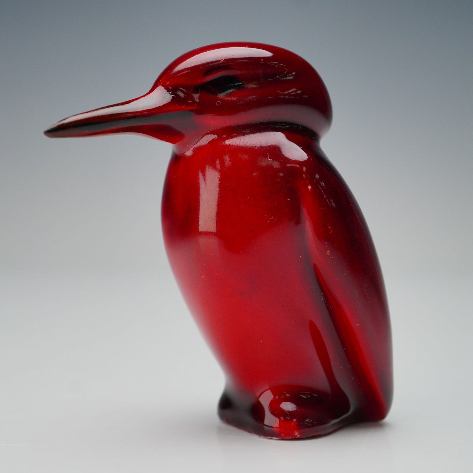 Royal Doulton Rare Flambe Figurine, Kingfisher Standing: A striking Royal Doulton Flambe Kingfisher figurine. Very rare free-standing model. Modeled in a deep red flambe glaze with subtle tonal variations, capturing the sleek form of kingfisher with smooth,