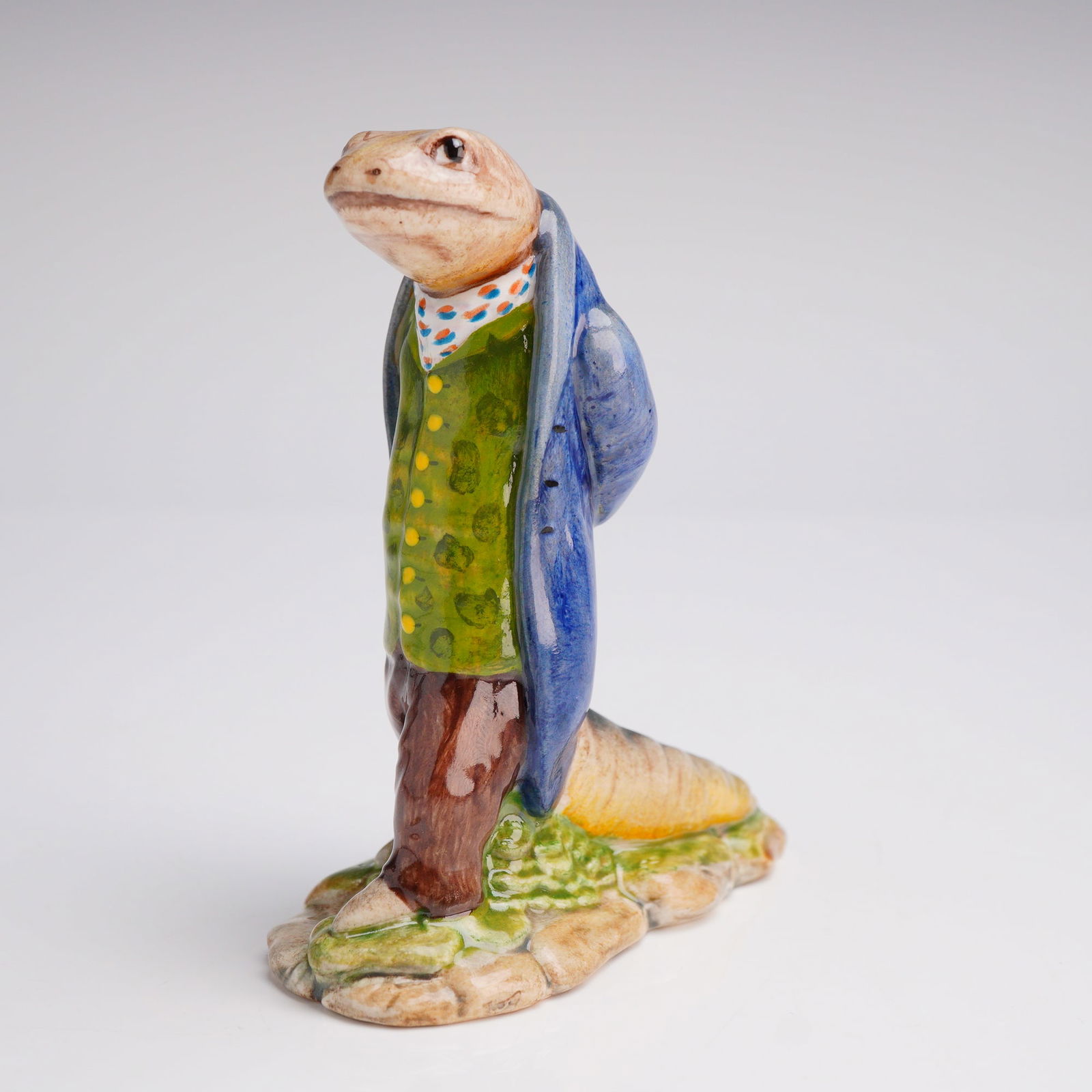 Royal Doulton Prototype Beatrix Potter Figurine, Sir Isaac Newton: An outstanding rare prototype of Sir Isaac Newton beautifully decorated in a shaded pale blue overcoat, olive brocade waistcoat with yellow buttons, orange and green patterned white cravat, and brown