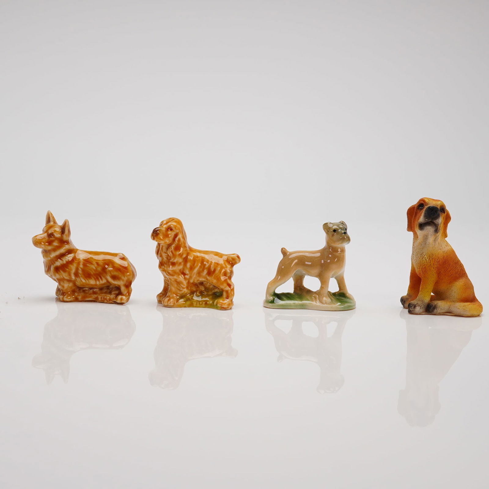 A Collection of 4 Miniature Ceramic and Resin Dog Figurines (1 of 3)