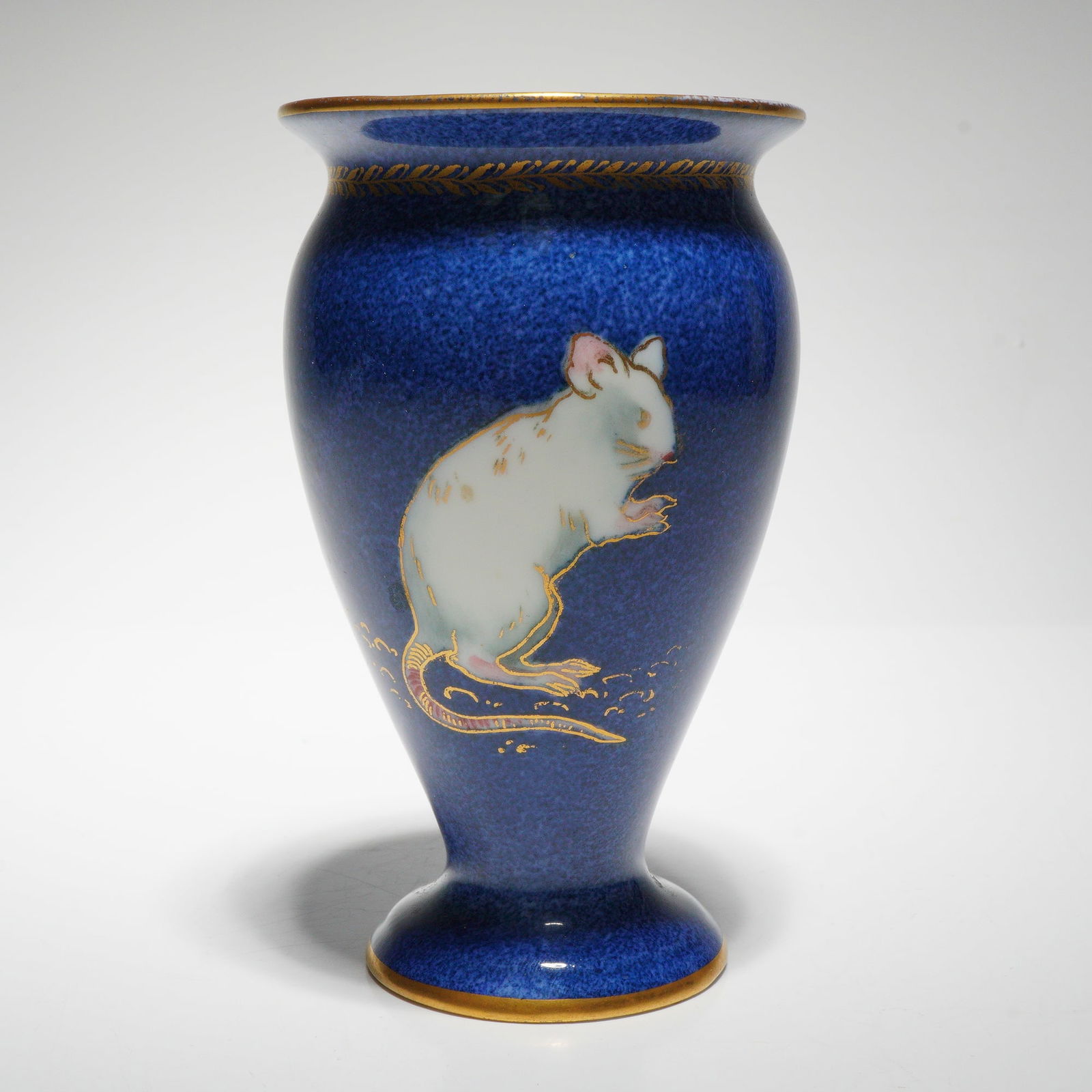 Wedgwood by James Hodgkiss Lustreware Vase, Dormouse: This vase is part of the Animal series depicting a delicate dormouse motif executed in soft tones and outlined in gold. The mouse design rests upon a deep mottled blue ground with a subtle iridescent