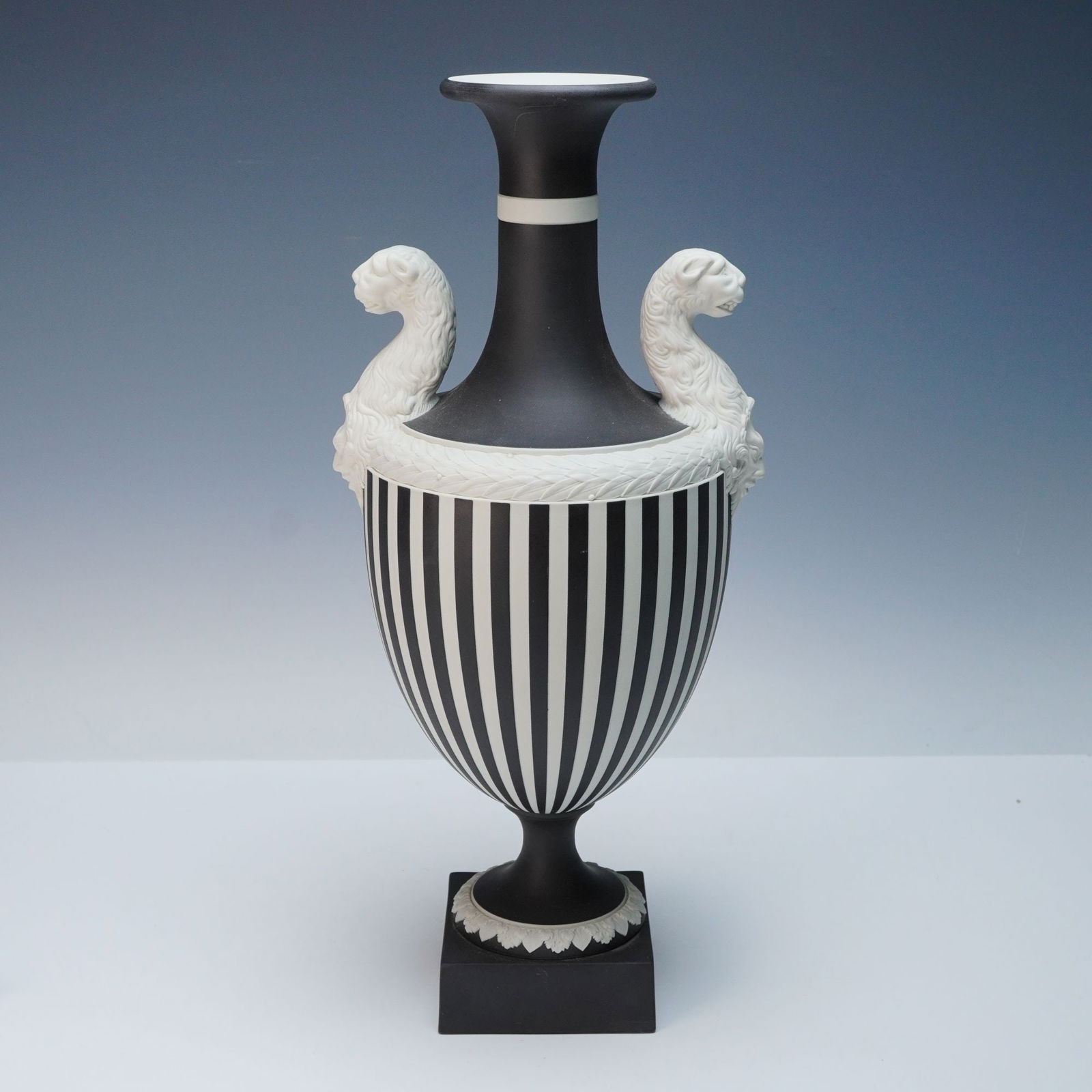 Wedgwood Limited Edition Prestige Collection Panther Black Basalt Urn: A Wedgwood Limited Edition Prestige Collection Panther Urn, crafted in Neoclassical-style black basalt with contrasting white bas-relief details. The urn features a flared rim, a constricted neck with