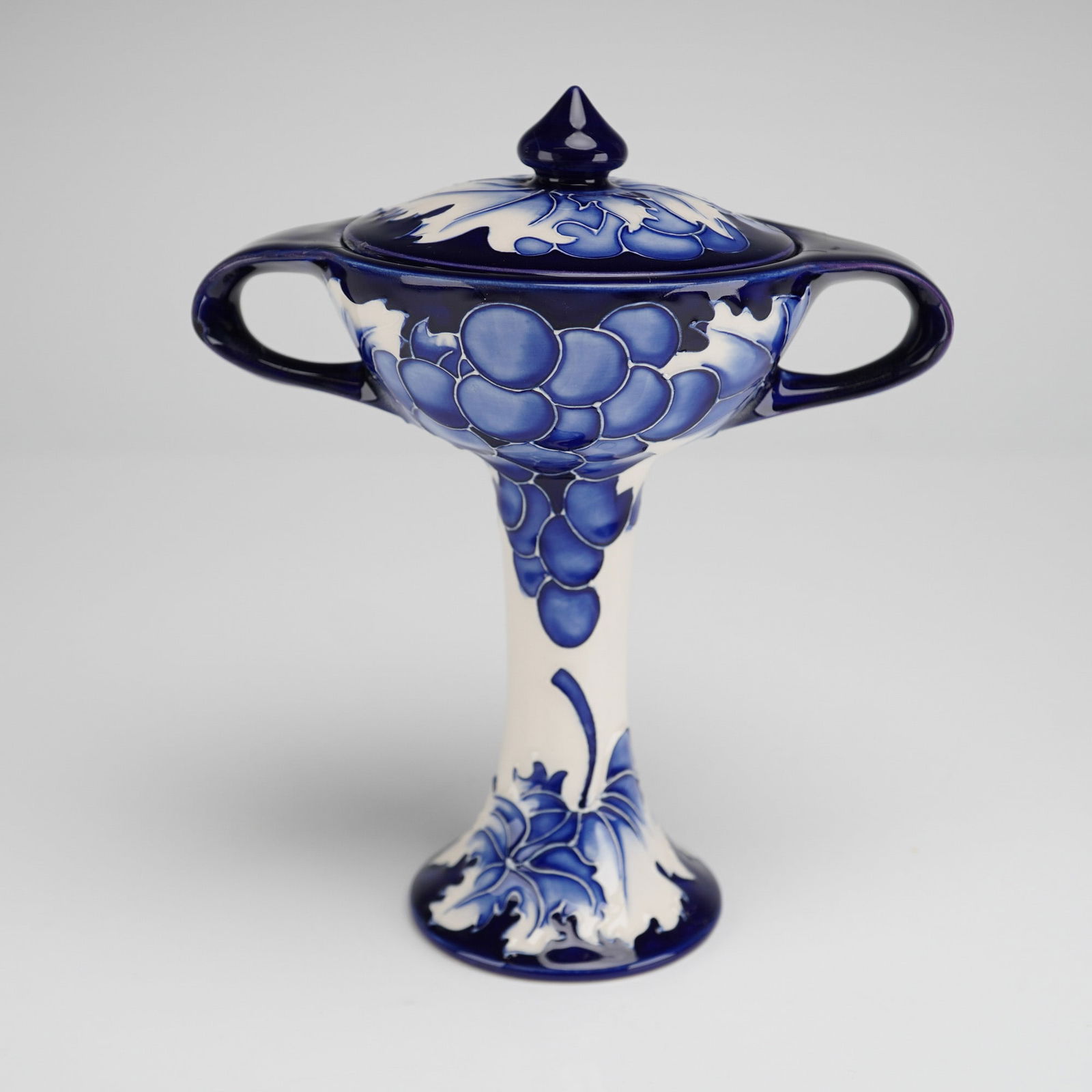 Moorcroft by Kerry Goodwin Bonbonniere, Blue Vine Nostalgia: A Moorcroft Blue Vine Nostalgia chalice, shape 28/6, numbered No. 8 in the edition. The piece is decorated in rich tubelined detail with the Blue Vine design, featuring stylised foliage and berries