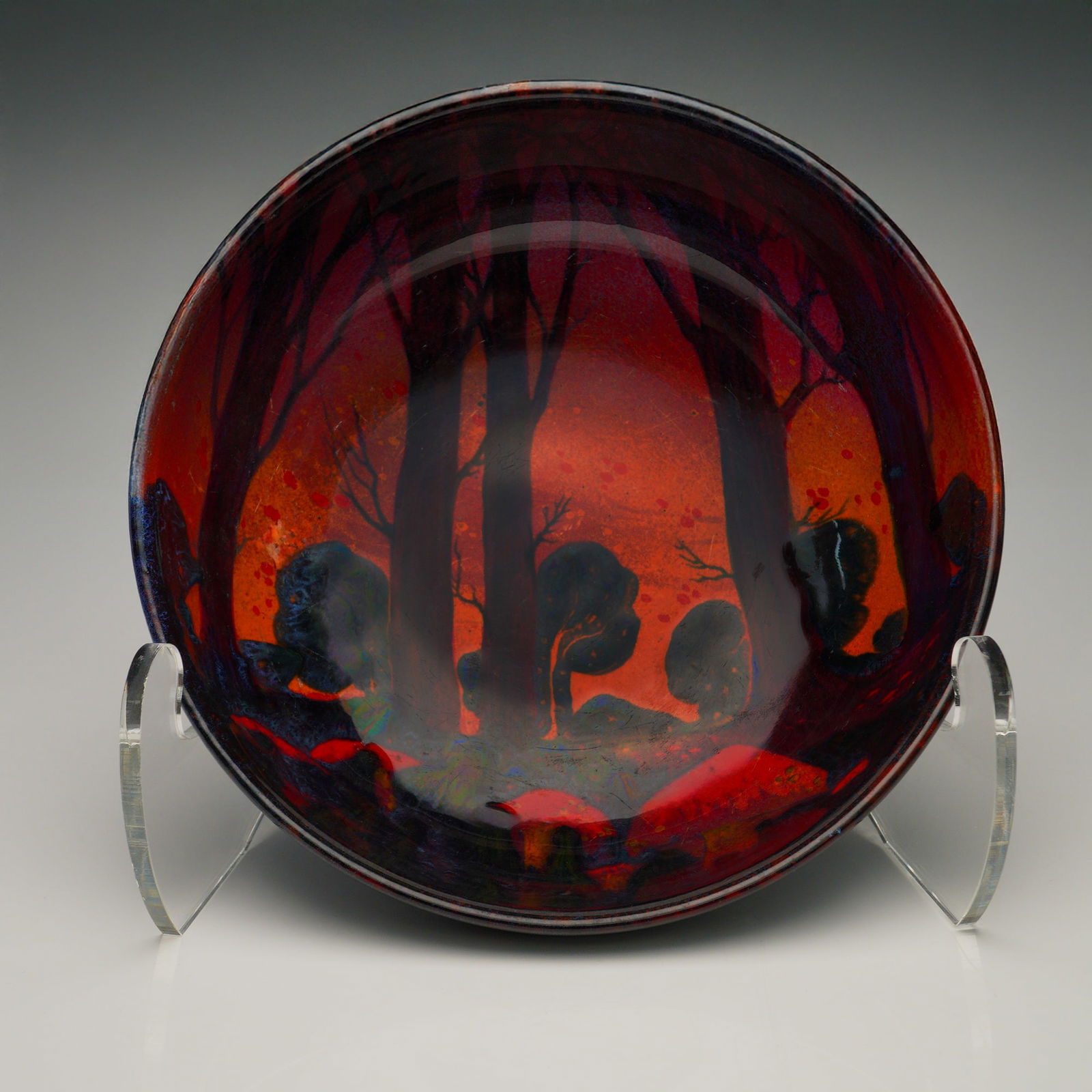 Royal Doulton Flambe Sung Mushrooms Forest Scene Bowl: Royal Doulton flambe glazed porcelain bowl featuring a vivid interior scene of a shadowed forest rendered in deep crimson and burnt-orange tones. The design includes tall, bare trees and stylized unde