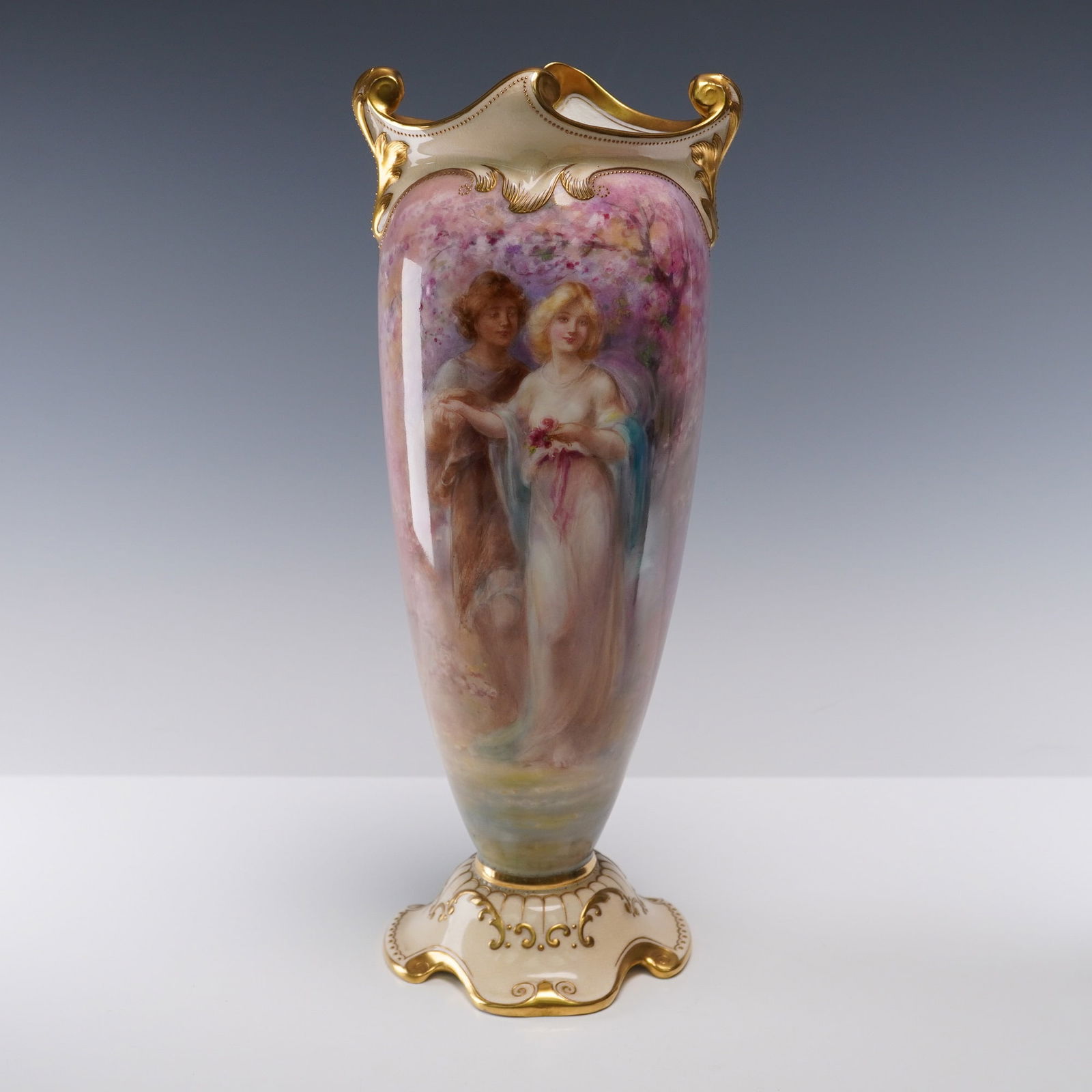 Royal Doulton by George White Vase, Love's: The baluster form is adorned with a continuous romantic scene in a pastel palette, depicting a classical male and female couple amid blossoming trees, surrounded by pastoral imagery including sheep. T