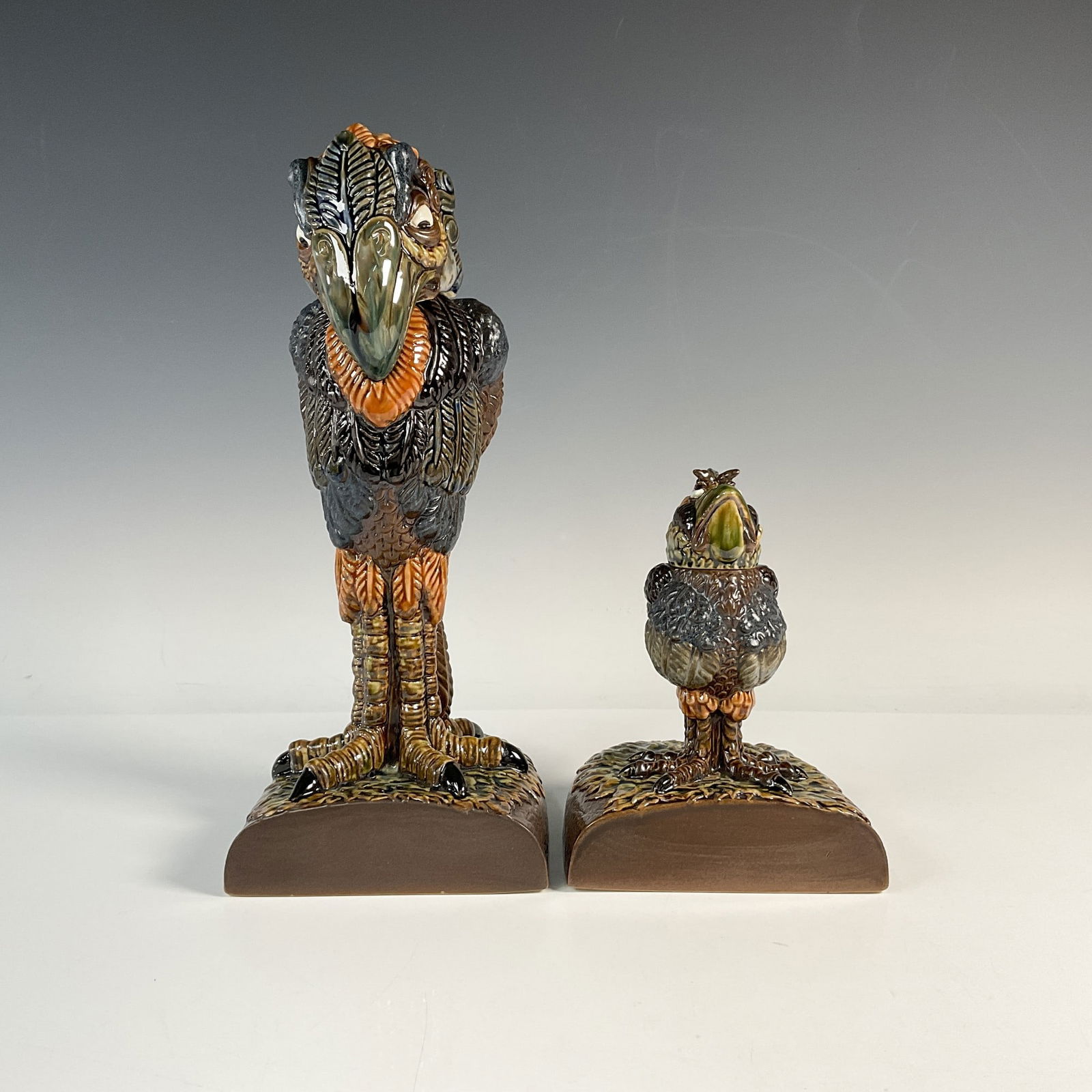 2pc Andrew Hull Stoneware Grotesque Bird Bookends, Signed: Unfortunate Offspring. Rare, limited edition 8 of 10. Hand modelled and hand painted pottery figural bookends; one of a small bird looking up, and the other is a tall bird looking down. Together the b