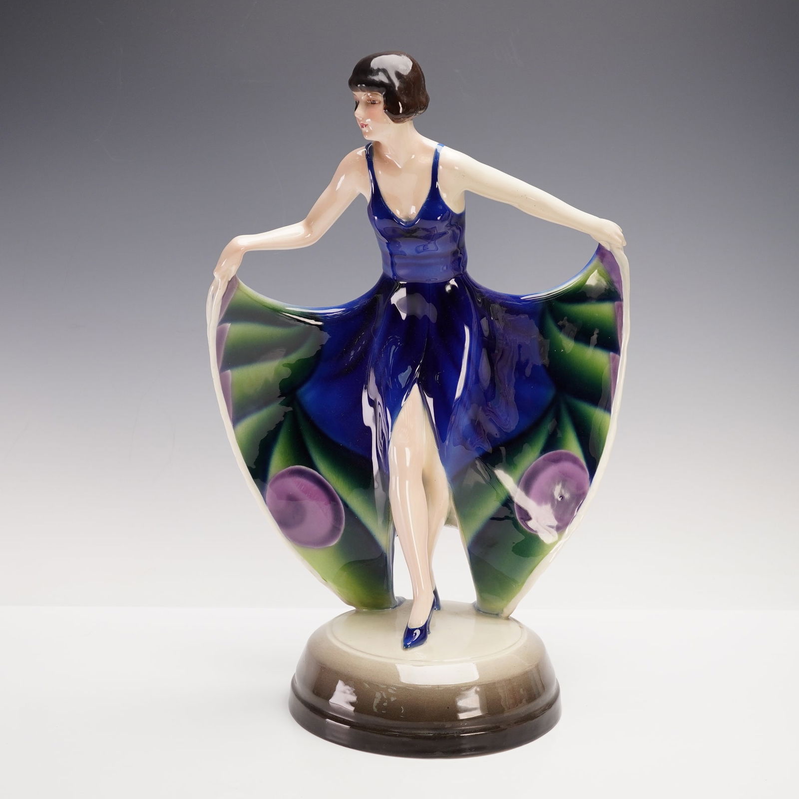 Goldscheider by Josef Lorenzl Woman in Butterfly Dress Figurine: An exquisite Art Deco porcelain figure by Goldscheider Wien, modeled by Josef Lorenzl. The sculpture portrays a poised young woman in a deep cobalt dress, the wide folds of which open like butterfly