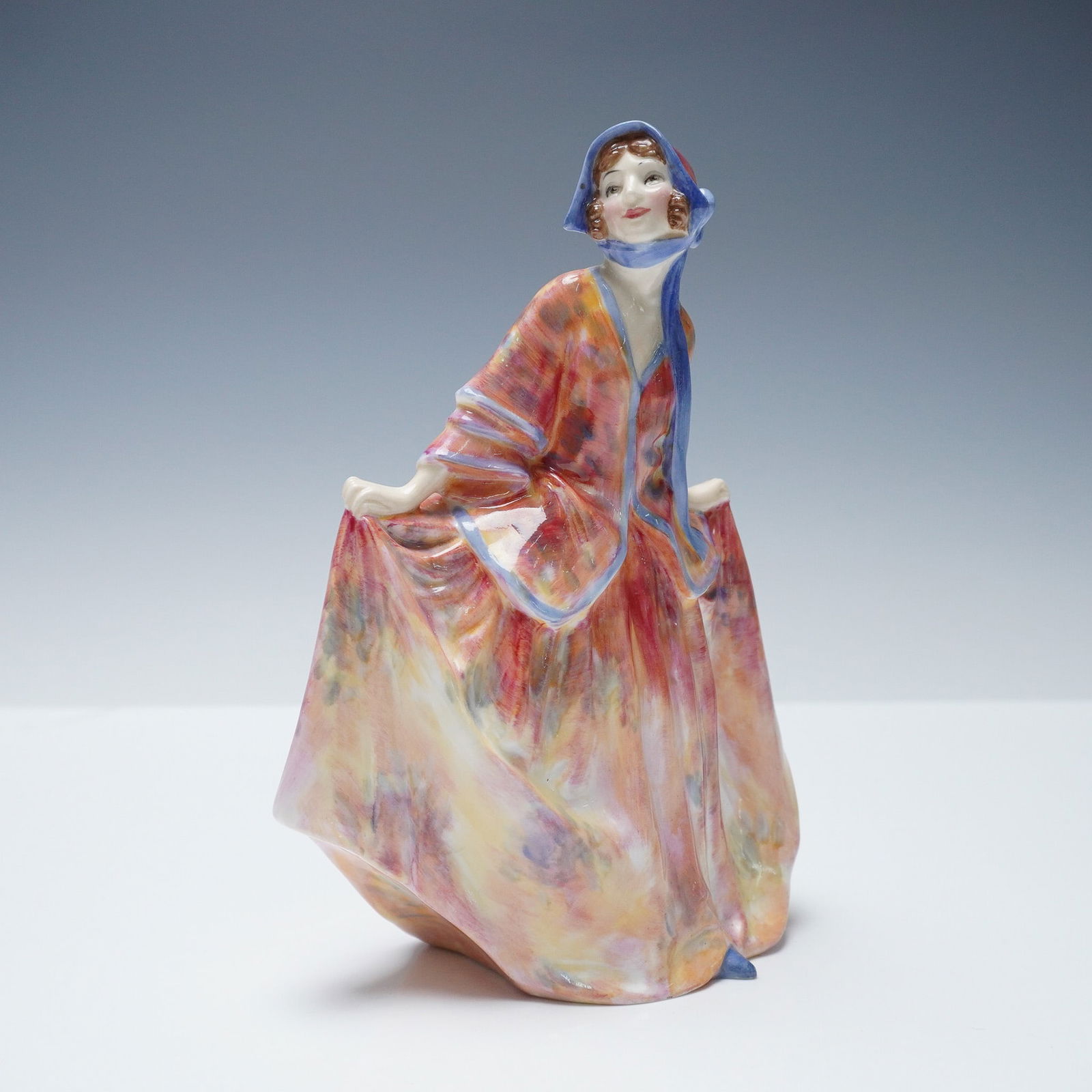 Royal Doulton Figurine, Sweet Anne HN1701, Very Rare Version: This hand-painted figure depicts a standing woman in a sweeping dress decorated in mottled shades of pink and blue. She wears a matching bonnet with blue trim and holds both sides of her gown. The