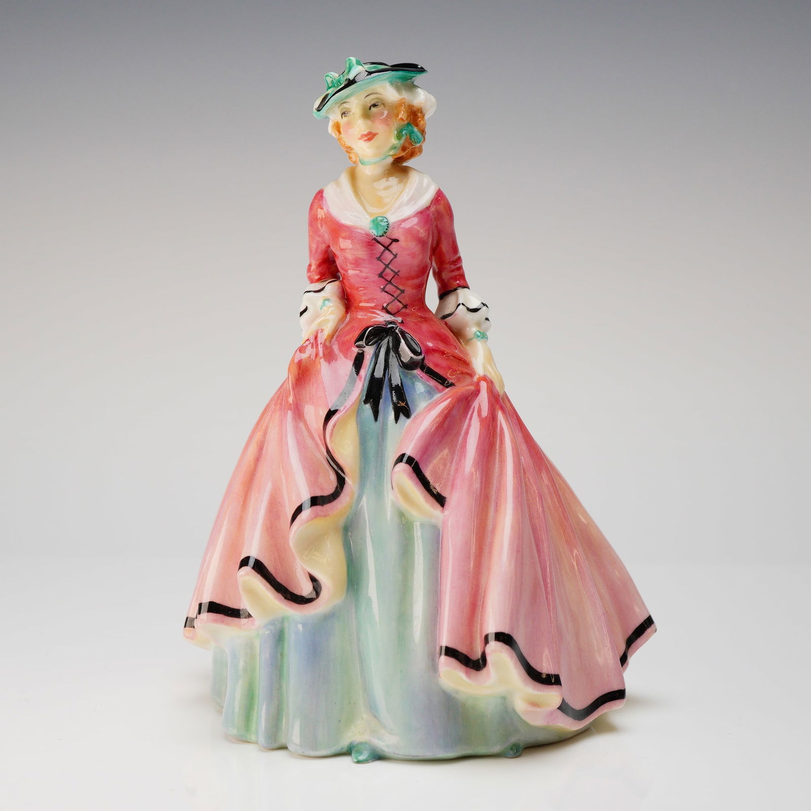Royal Doulton Sweet Suzy HN1918 Figurine: A single glazed bone china figurine by Royal Doulton, titled Sweet Suzy, model number HN 1918. The figure depicts a young woman in a voluminous, period-style dress, attributed to Leslie Harradine and