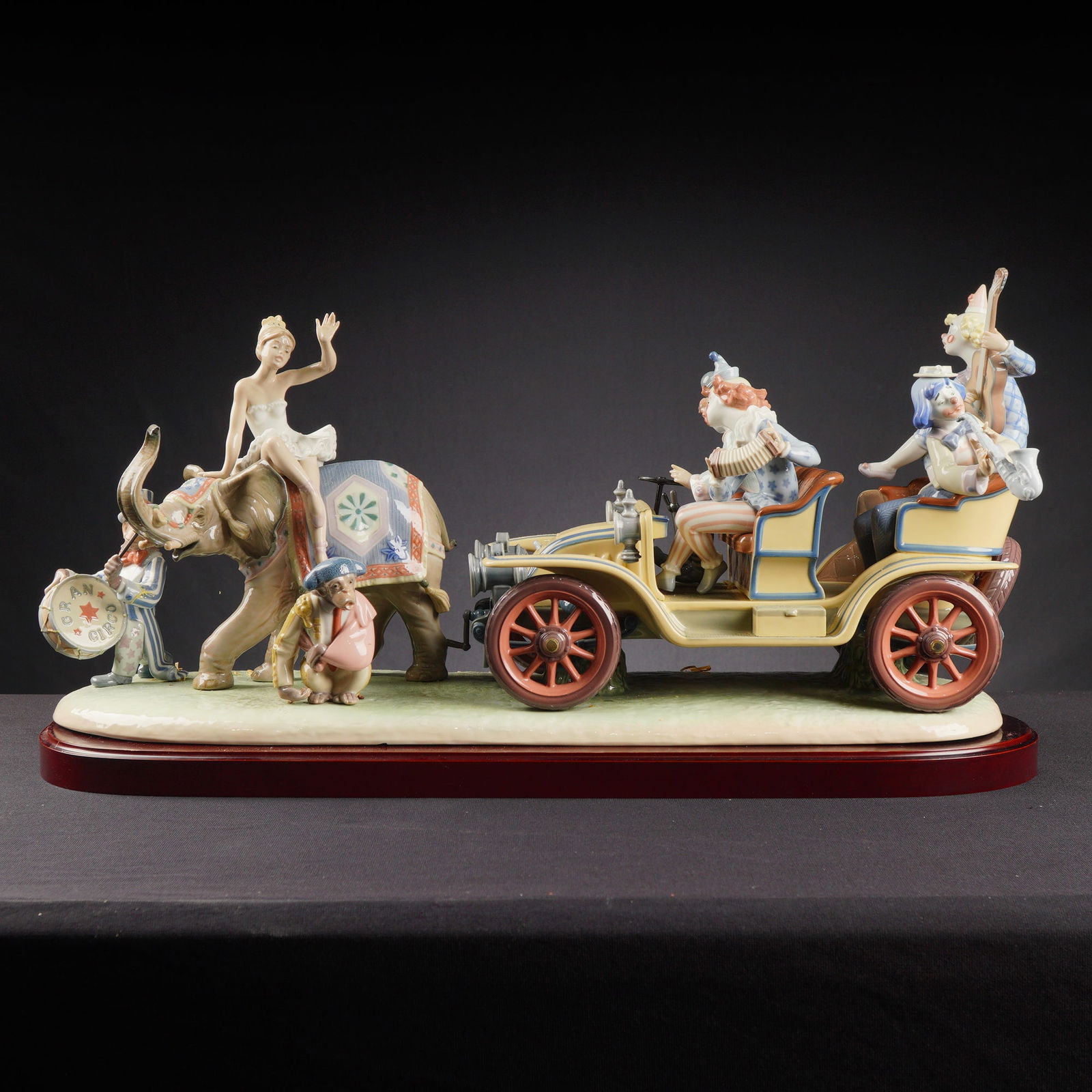 Lladro Porcelain Sculpture Circus Parade 1001609: A limited edition Lladro Porcelain Sculpture titled Circus Parade, model number 01001609. The large figural group depicts a circus procession utilizing a glossy polychrome glaze. The scene features a