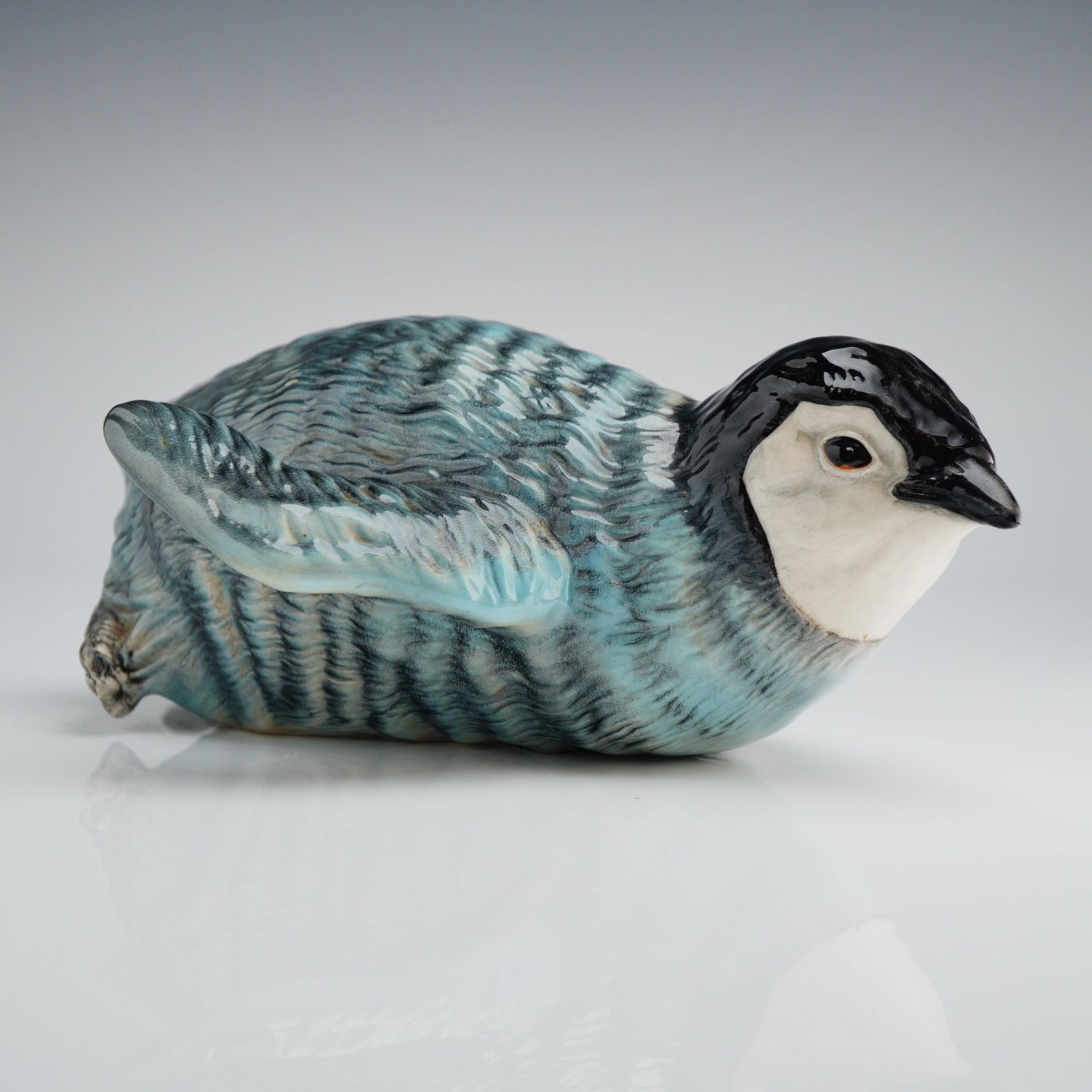 Beswick Sliding Penguin Chick Ceramic Figurine Model 2434: A single ceramic figurine manufactured by Beswick, England, identified through market consensus as the 'Sliding Penguin Chick,' Model No. 2434. The piece is modeled as a juvenile penguin chick depicte
