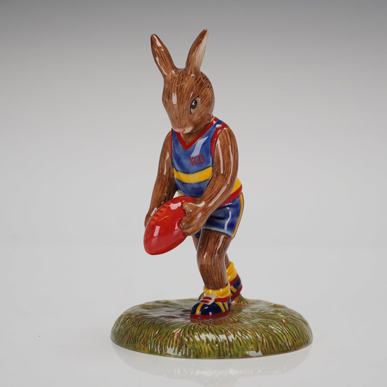 Royal Doulton Bunnykins Aussie Rules Figurine DB508 Ltd Ed.: A single Hand Decorated Earthenware Bunnykins figurine by Royal Doulton, identified as the Aussie Rules Bunnykins, model number DB 508. This piece was commissioned by WWRD Australia and copyrighted