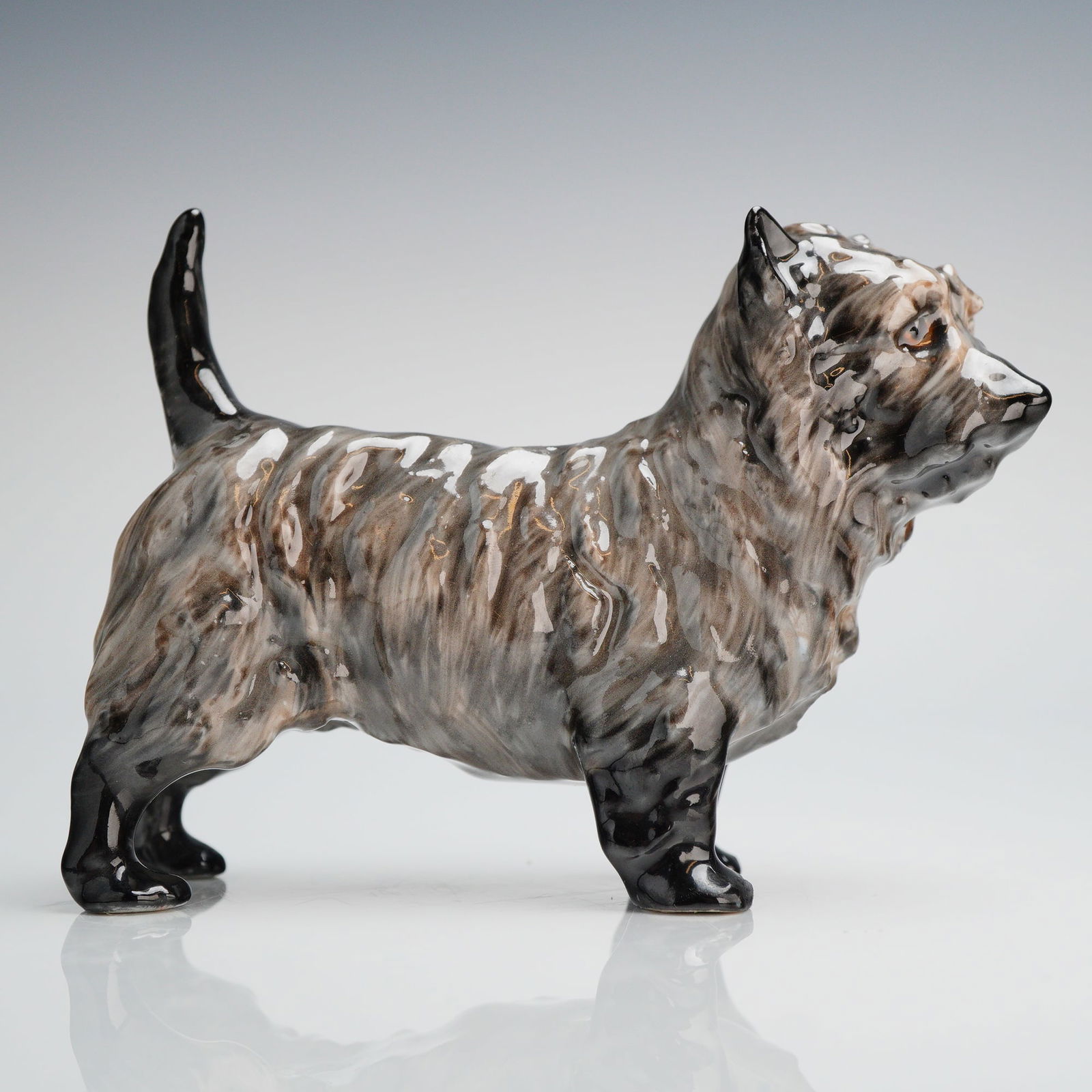Royal Doulton Bone China Cairn Terrier Figurine Charming Eyes HN1035: A Royal Doulton glazed china figurine modeled as a standing Cairn Terrier, widely recognized by the collector's designation HN1035, and sometimes referred to as "Charming Eyes." The figurine is