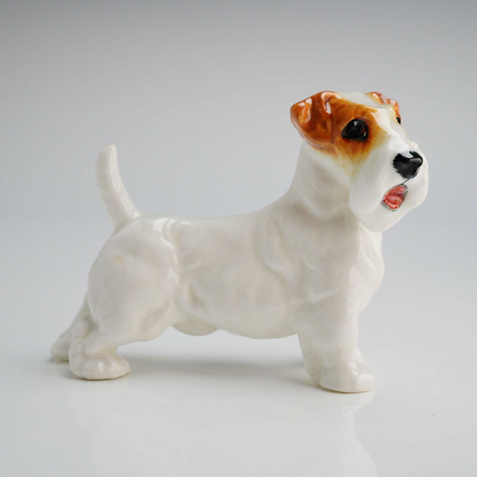 Royal Doulton Sealyham Terrier Figurine HN 2509: A glazed porcelain figurine manufactured by Royal Doulton, identified by the model number HN 2509, commonly known in the market as the Sealyham Terrier. The figure depicts a standing terrier dog