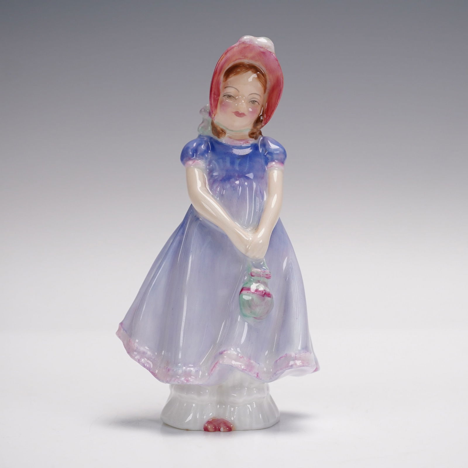 Royal Doulton Ivy HN1768 Figurine: Graceful Royal Doulton figurine titled Ivy, model HN1768, designed by Leslie Harradine and issued in 1936. This hand-painted bone china figure depicts a young woman in a flowing floral-patterned dress