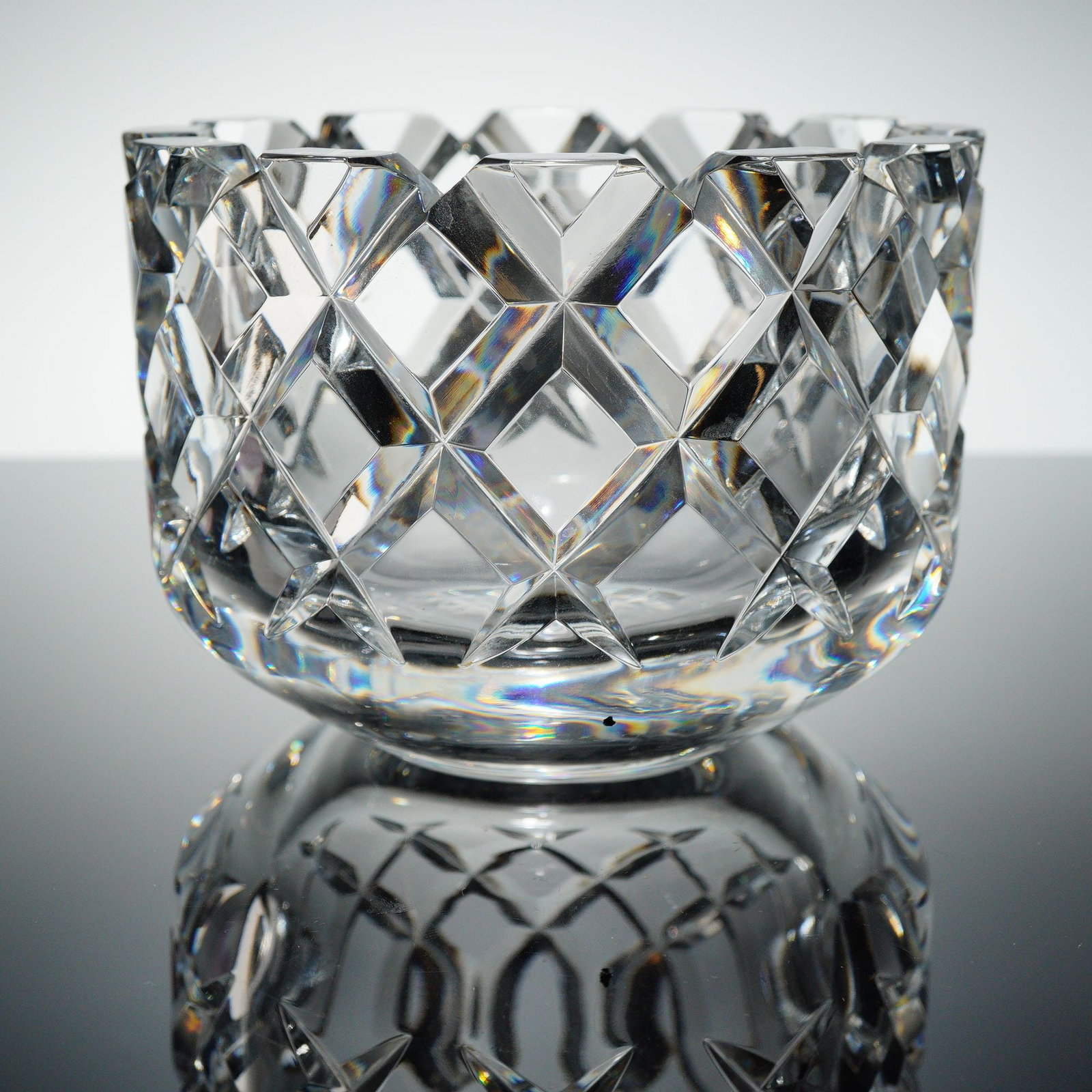 Orrefors Sofiero Cut Crystal Bowl: A clear Orrefors Crystal bowl in the renowned Sofiero patern. The heavy crystal container features a brilliant cut geometric patern composed of deep diamond facets covering the body. The rim is scallo