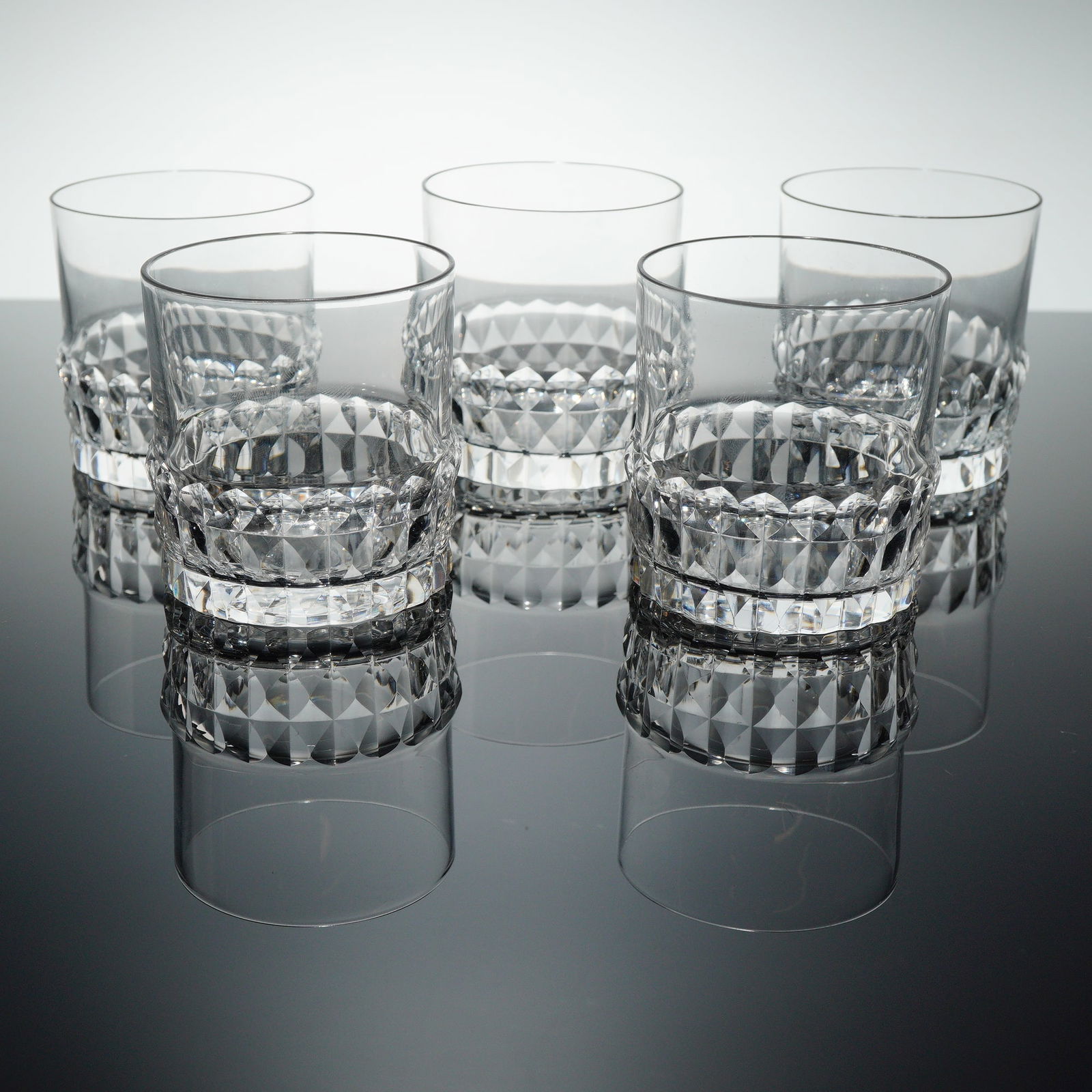 A Collection of 5 Orrefors Cut Crystal Double Old Fashioned Tumblers: A collection of five (5) Orrefors crystal tumblers, designed as Double Old Fashioned (DOF) or whiskey glasses. Each tumbler is crafted from heavy, clear cut crystal featuring thick walls and a solid b