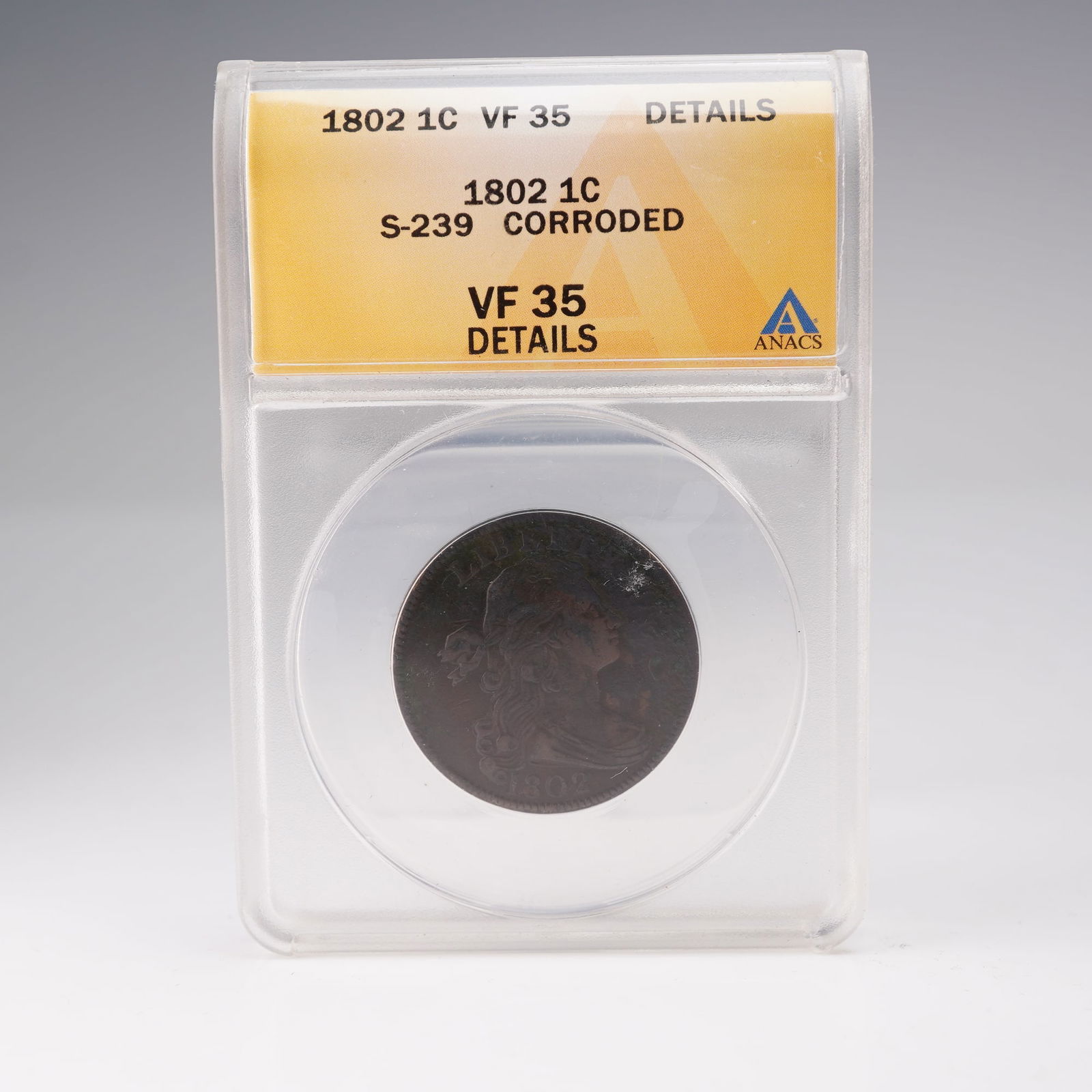 1802 Draped Bust Large Cent S-239 ANACS Graded VF 35 Details: An early U.S. copper coin, this 1802 Draped Bust Large Cent (S-239) has been graded VF 35 Details by ANACS, with notation of corrosion. The obverse displays Liberty with flowing hair tied with a ribbo
