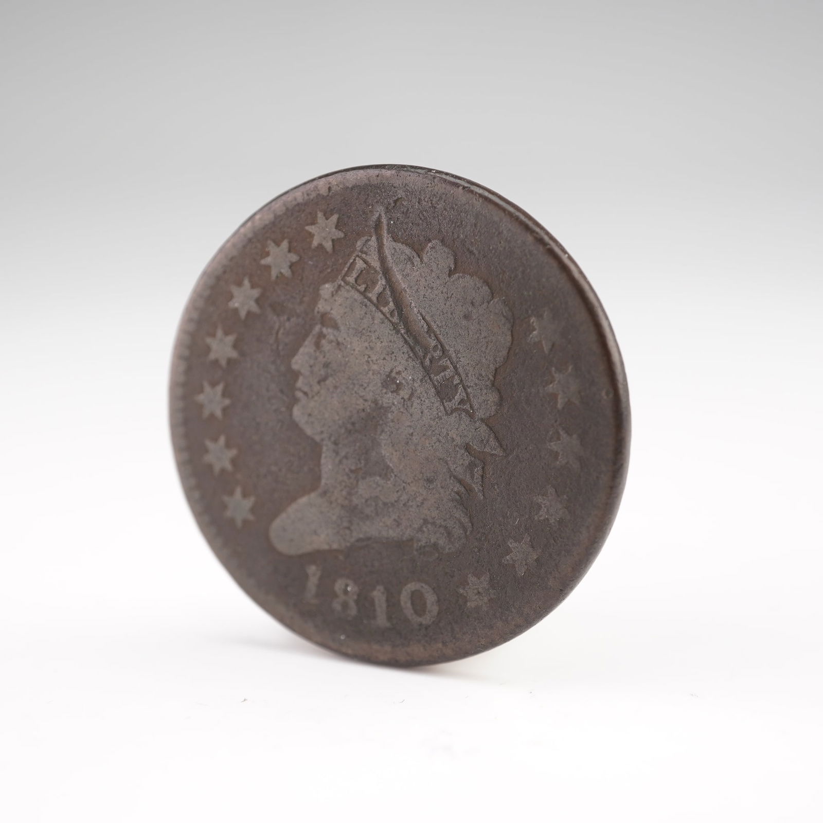 1810 Classic Head Large One Cent: An early U.S. copper large cent dated 1810, struck at the Philadelphia Mint and featuring the Classic Head design introduced by John Reich. The obverse depicts a left-facing portrait of Liberty wearin