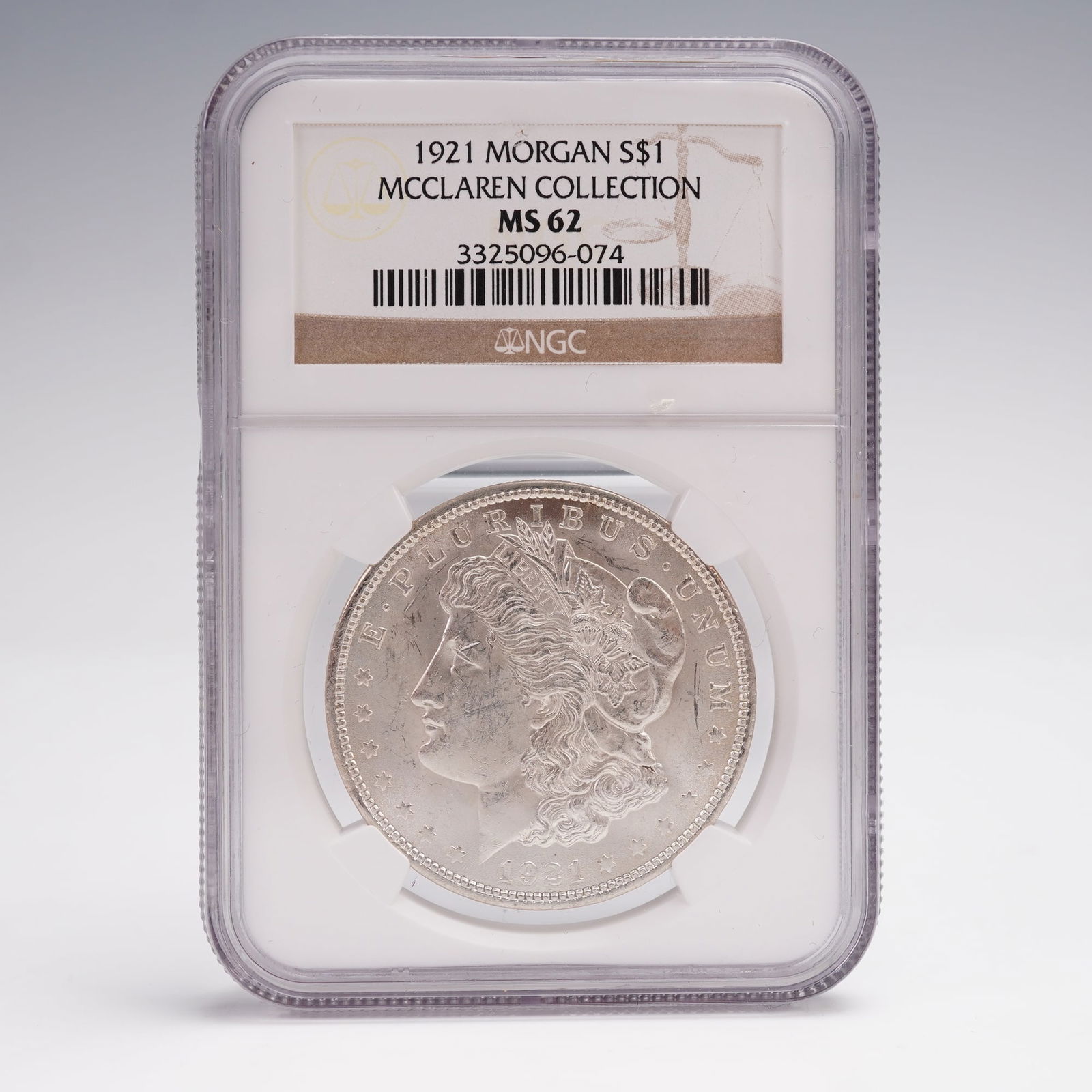 1921 Morgan Silver Dollar NGC Graded MS 62 McClaren Collection: Struck in 1921, this Morgan Silver Dollar comes from the McClaren Collection and has been graded MS 62 by NGC. The obverse features the portrait of Liberty wearing a Phrygian cap, adorned with agricul