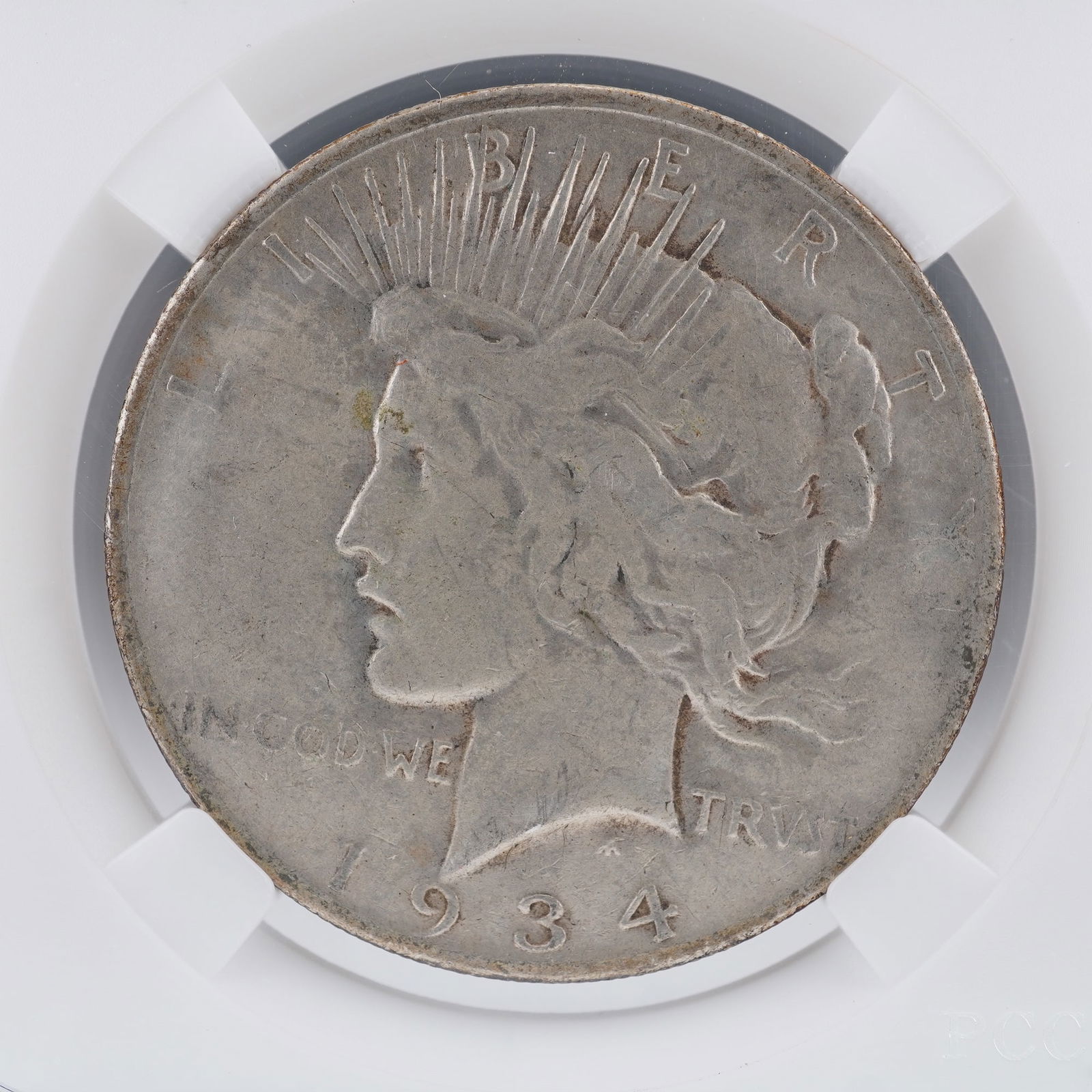 1934-S Peace Silver Dollar: A 1934-S Peace Silver Dollar, struck at the San Francisco Mint and designed by Anthony de Francisci. The obverse features Liberty wearing a radiant crown symbolizing enlightenment and renewal, surroun