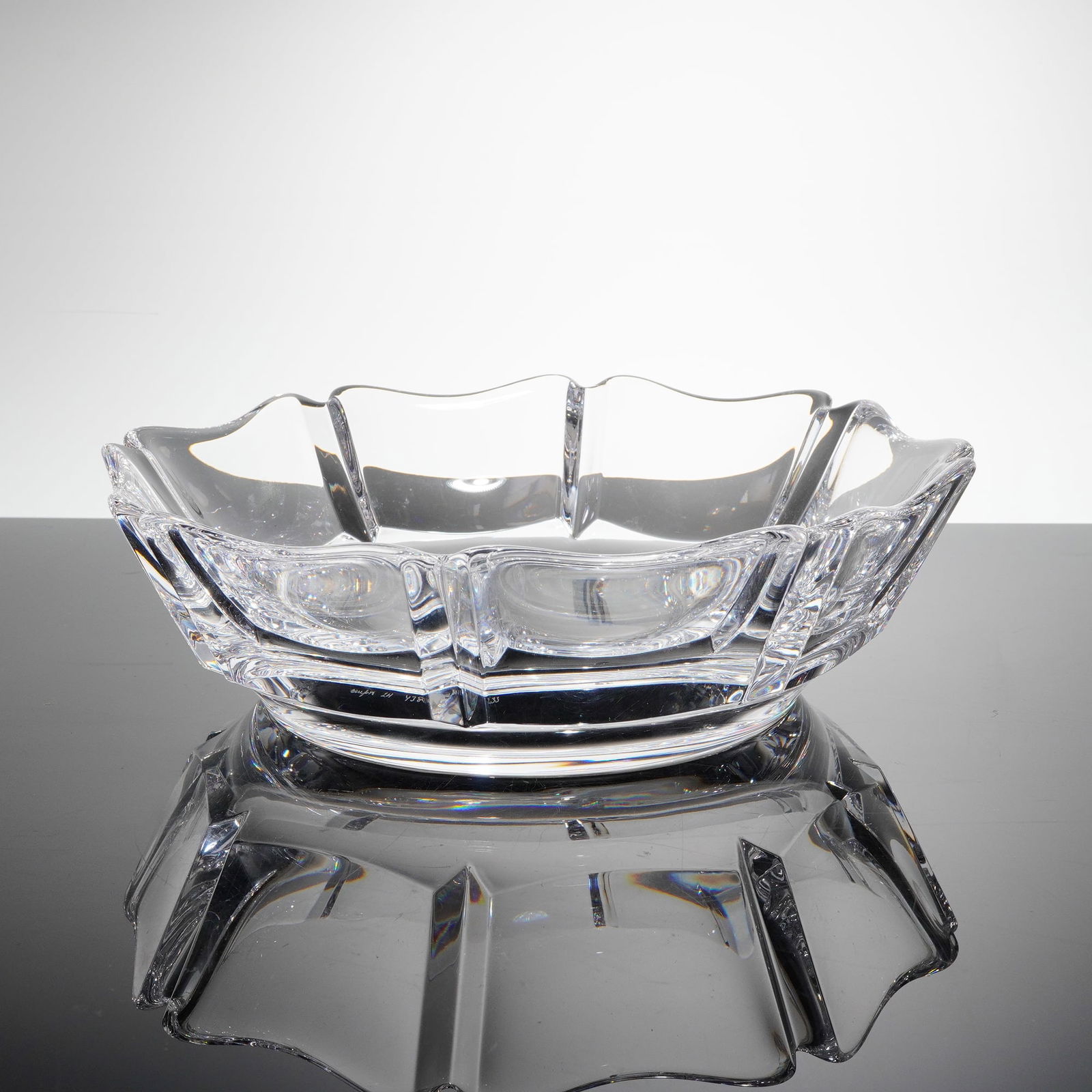 Orrefors Corona Crystal Bowl by Lars Hellsten: A modernist Orrefors Crystal bowl in the 'Corona' patern, designed by Lars Hellsten. This faceted clear crystal vessel features thick walls, a sturdy circular base, and sharp geometric cutting, culmin