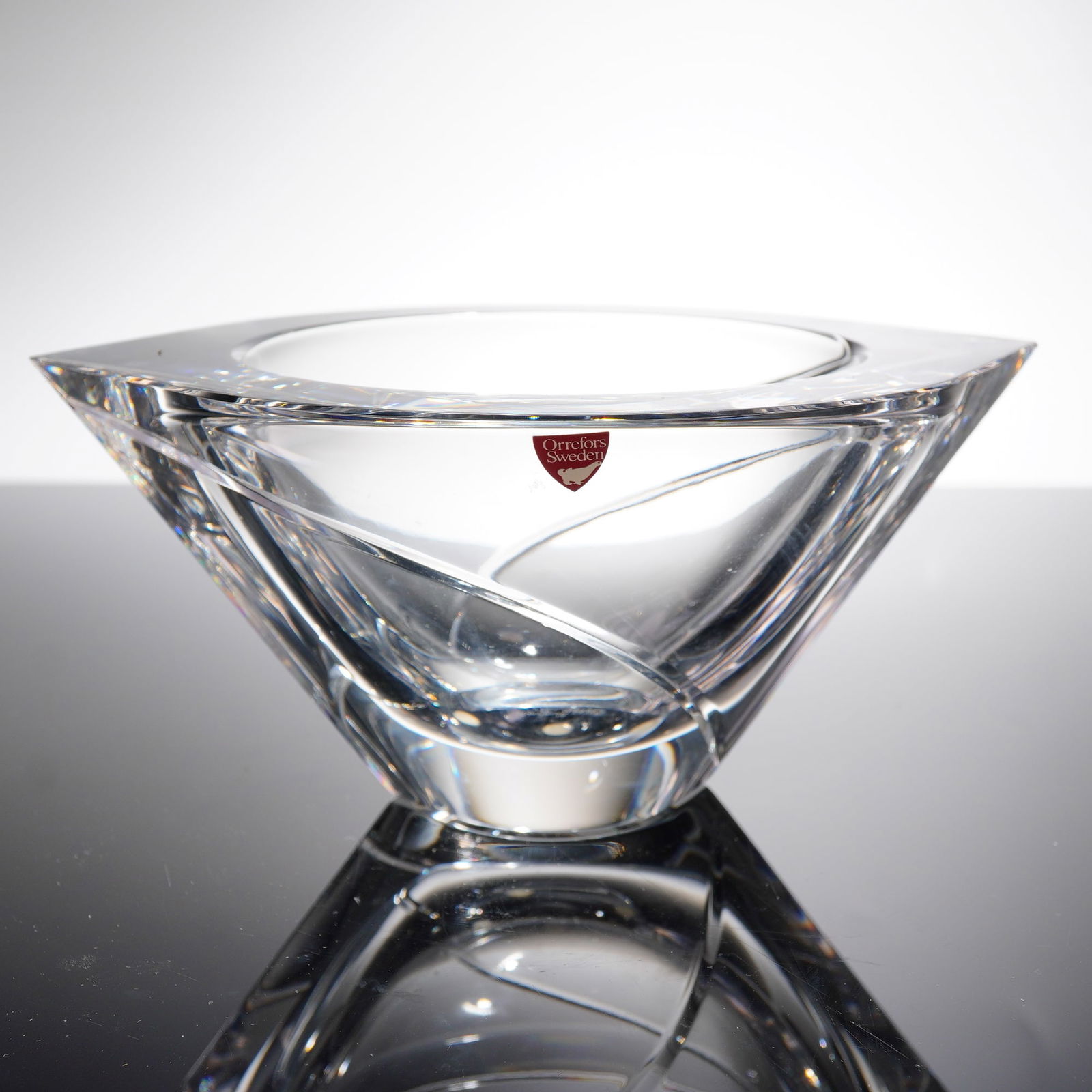 Orrefors Marin Crystal Bowl Designed by Jan Johansson: A single modern crystal bowl in the Marin patern, designed by Jan Johansson for Orrefors, Sweden. The vessel is executed in heavy, clear crystal, characterized by a square rim and dramatic, geometric