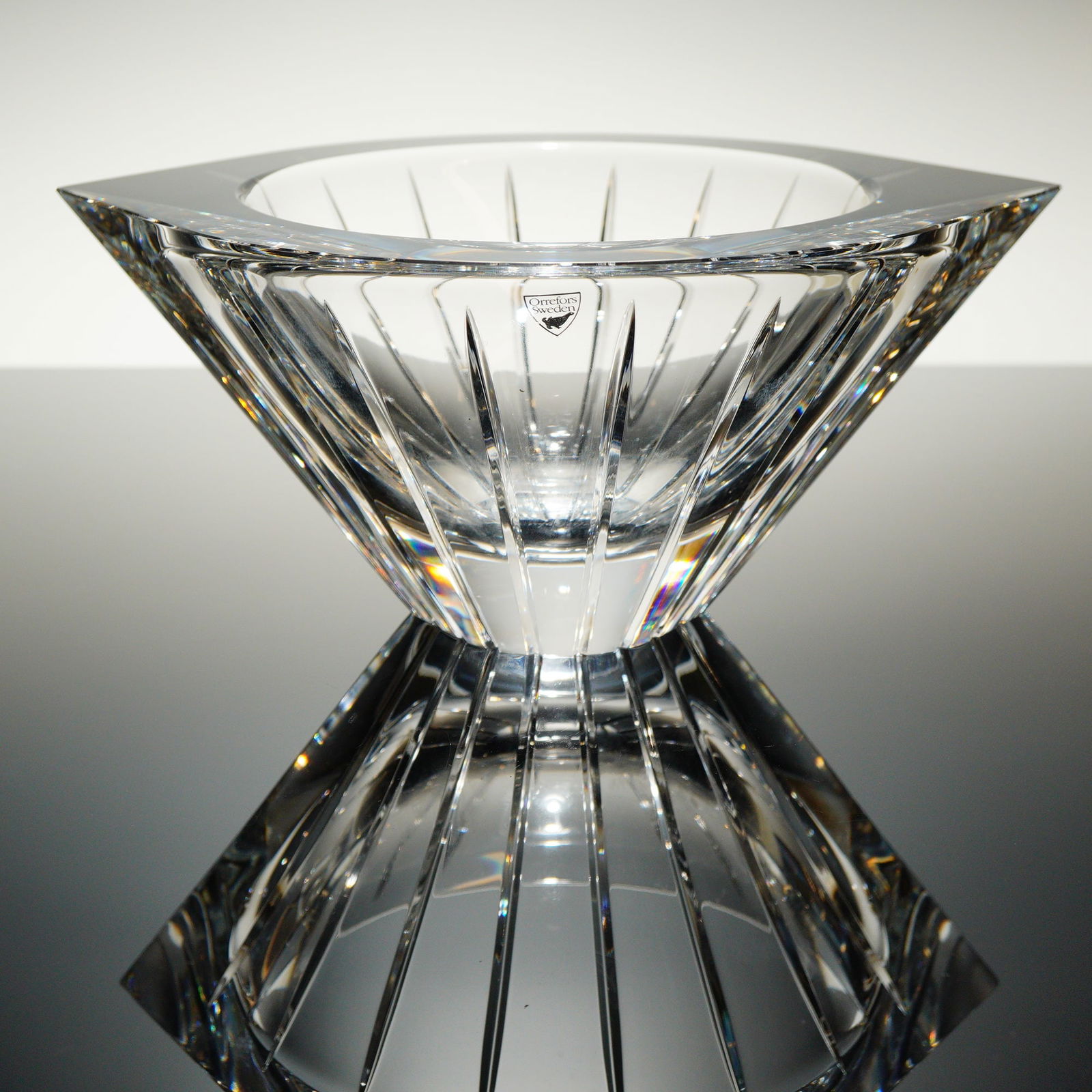 Orrefors Jan Johansson Marin Crystal Centerpiece Bowl: A heavy, clear crystal centerpiece bowl manufactured by Orrefors, Sweden, designed by Jan Johansson. The Modernist geometric design features a tapering body leading to a wide, octagonal rim. The form