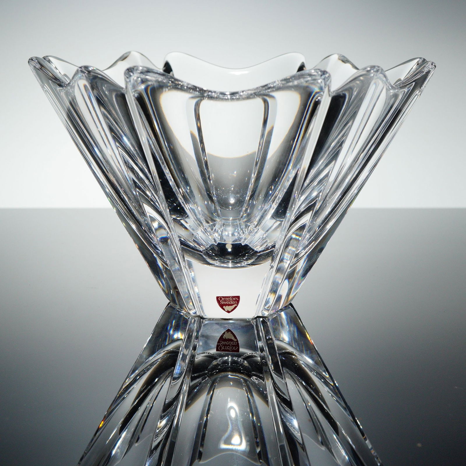 Orrefors Orion Crystal Bowl by Lars Hellsten: Orrefors "Orion" crystal bowl designed by Lars Hellsten. The bowl is formed of clear crystal with sharply faceted sides rising to a gently undulating rim, creating a sculptural profile that emphasizes