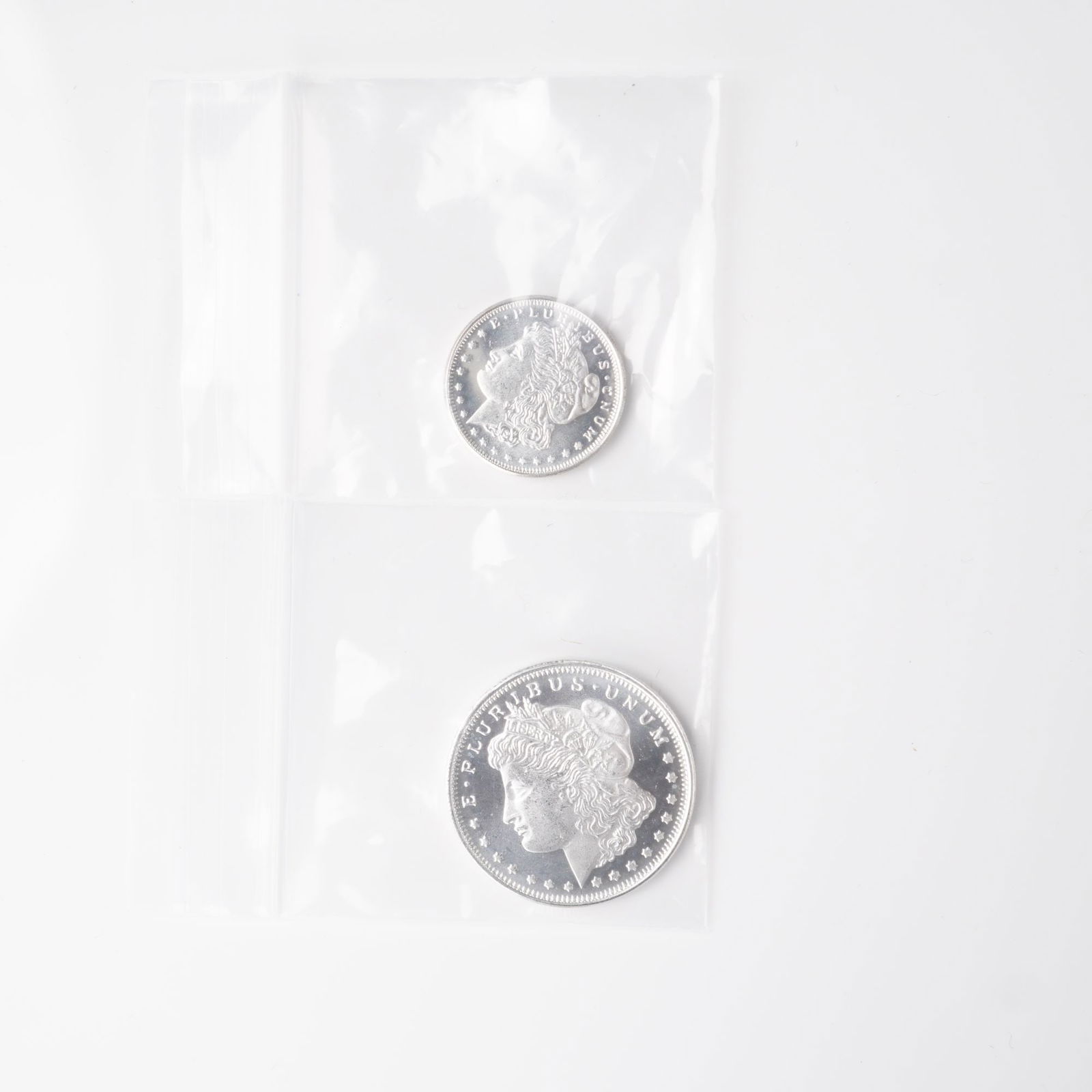 2pc 1/2 Troy Ounce and 1/4 Troy Ounce Morgan Silver Rounds: A two-piece lot of silver rounds, each composed of .999 fine silver and styled after the classic Morgan Dollar design. Both obverses display the iconic left-facing portrait of Lady Liberty wearing a P