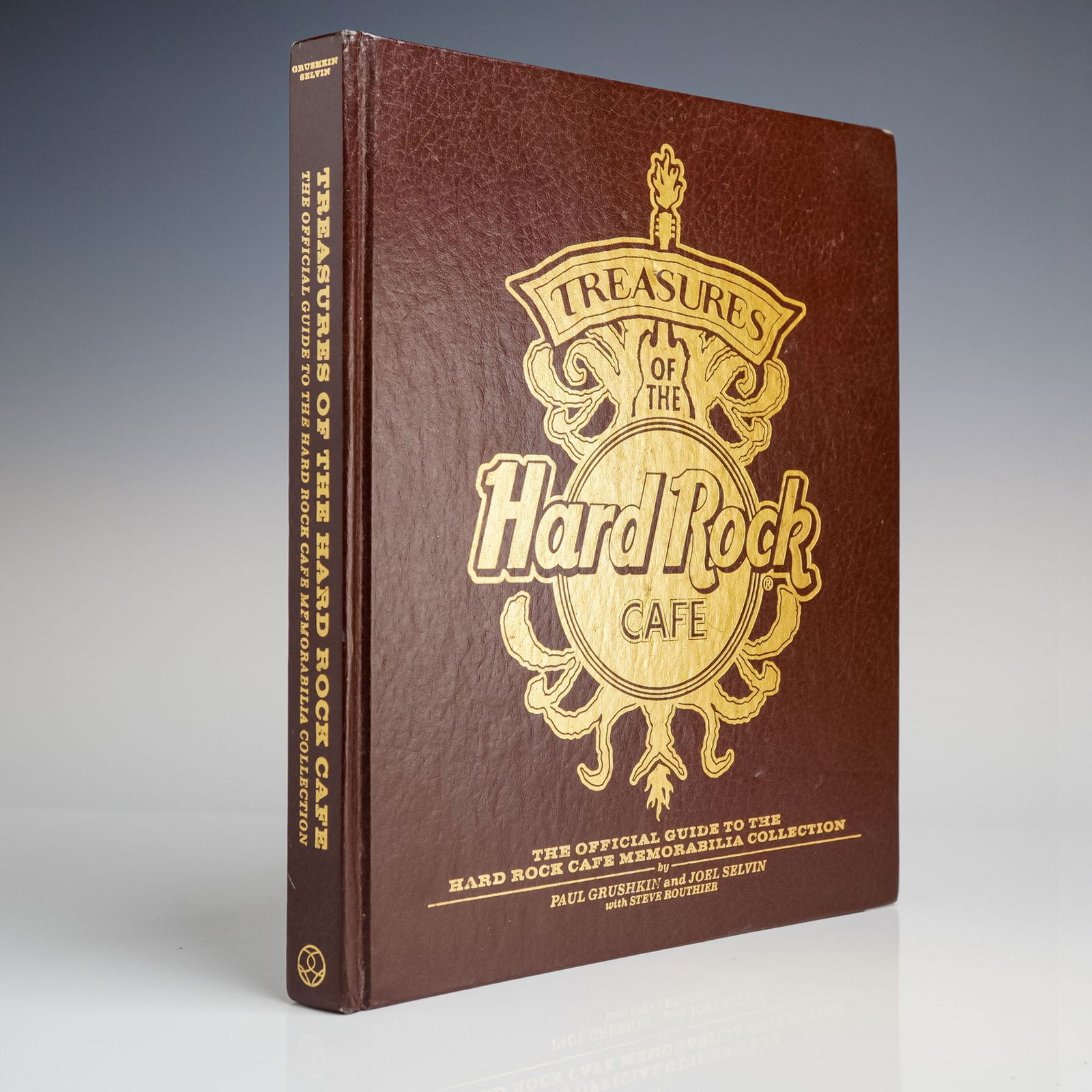 Treasures of the Hard Rock Cafe Hardcover Book: A single volume titled Treasures of the Hard Rock Cafe: The Official Guide to the Hard Rock Cafe Memorabilia Collection, authored by Paul Grushkin and Joel Selvin with Steve Routhier. This hardcover v