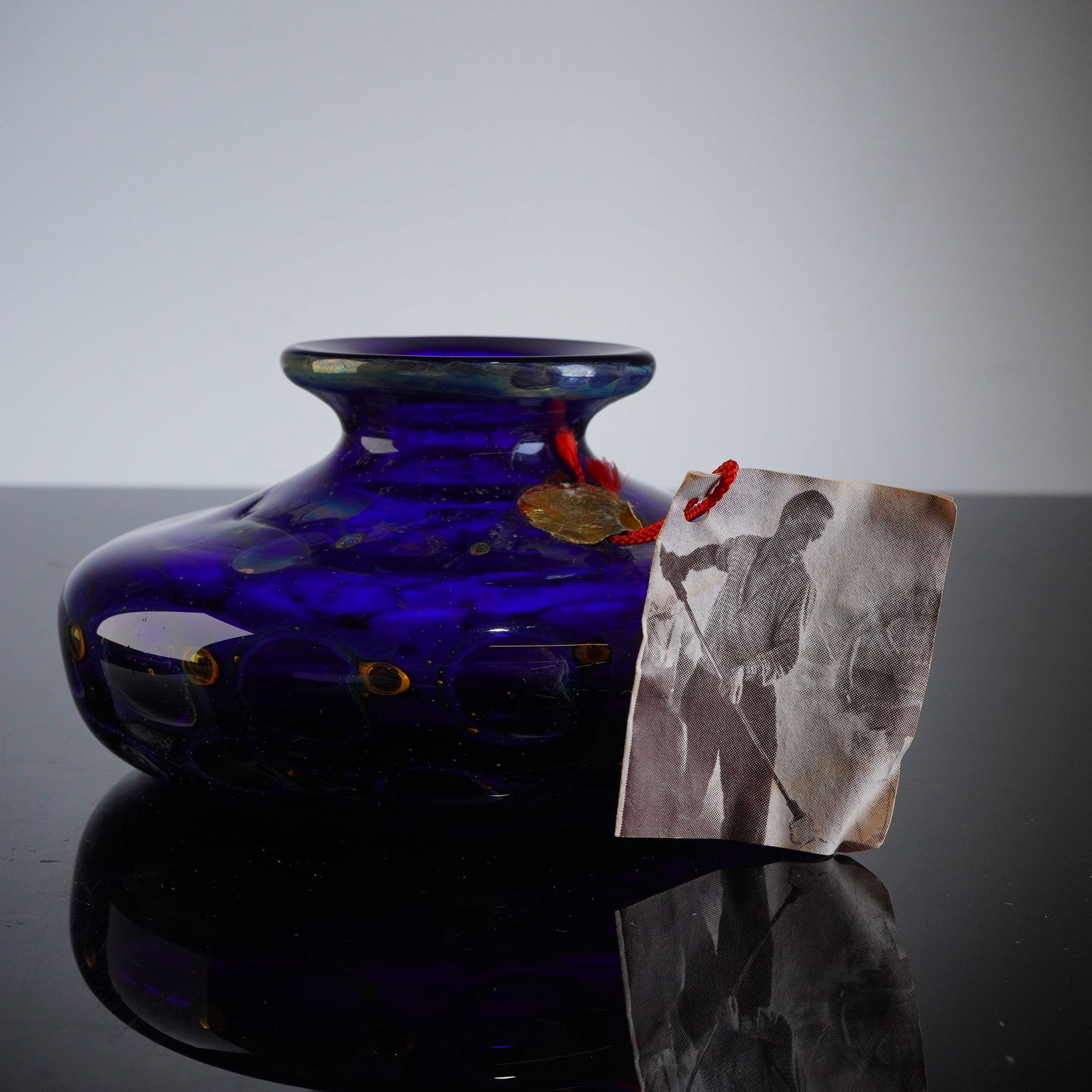 Eisch Studio Art Glass Cobalt Blue Vase, Nebula, Signed: A single hand-blown studio art glass vase attributed to Eisch, executed in a deep sapphire blue coloration. The vessel features a squat, wide-bodied form with a short neck and a wide, rolled rim. The