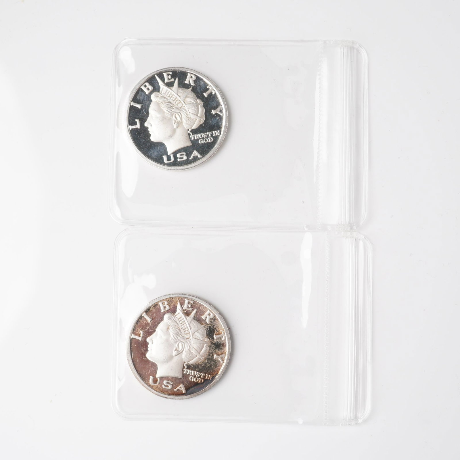 2pc 2003 1/2 Troy Ounce Five Dollar Silver Rounds: A set of two Liberty Dollar silver rounds, each struck in .999 fine silver and issued with a denomination of five dollars. The obverse design presents the classical bust of Liberty facing left, crowne