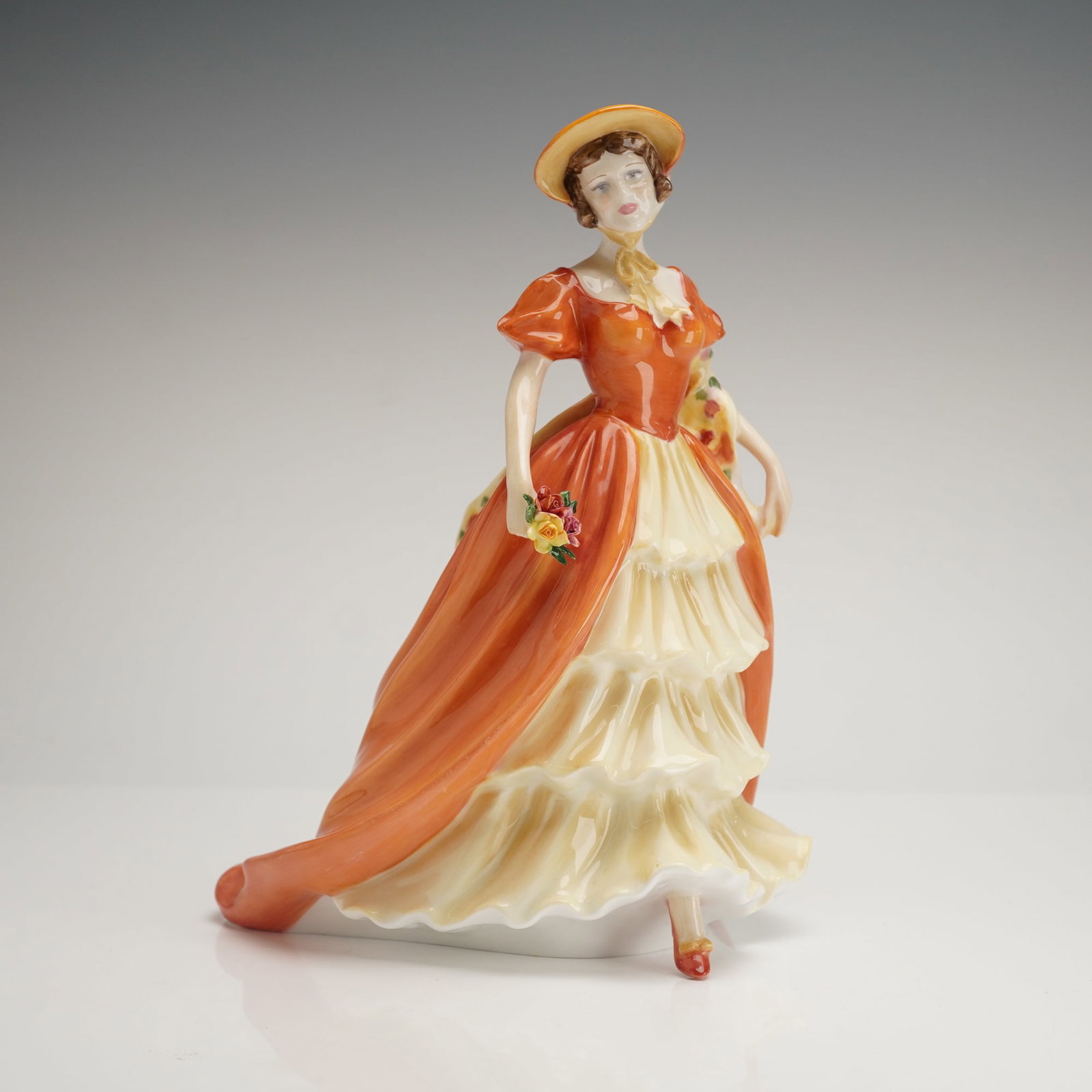 Royal Doulton Bone China Prestige Figurine, Lady Victoria May HN5131: 2008 Prestige Figure of the Year. This finely detailed bone china figure depicts Lady Victoria May in a russet, orange, and cream-colored Victorian ensemble. Modeled by Tim Potts, the figure features