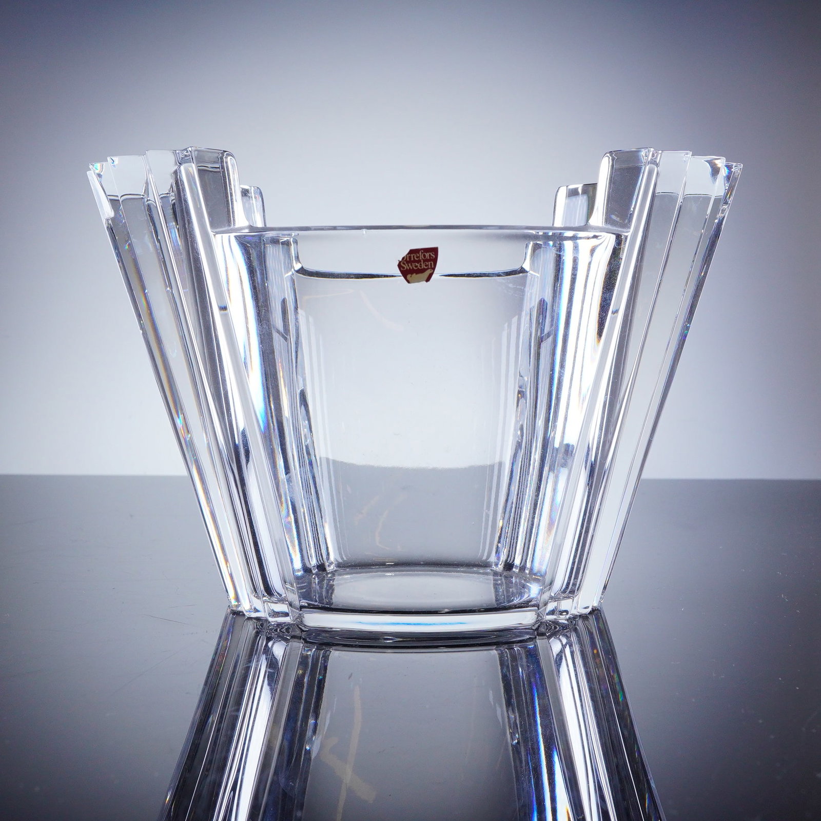 Helen Krantz for Orrefors Crystal Bowl: A modern cut crystal bowl produced by Orrefors, Sweden, designed by Helen Krantz. The piece features a geometric, tapering form defined by deep vertical facet cuts that create a sharp perimeter. It re