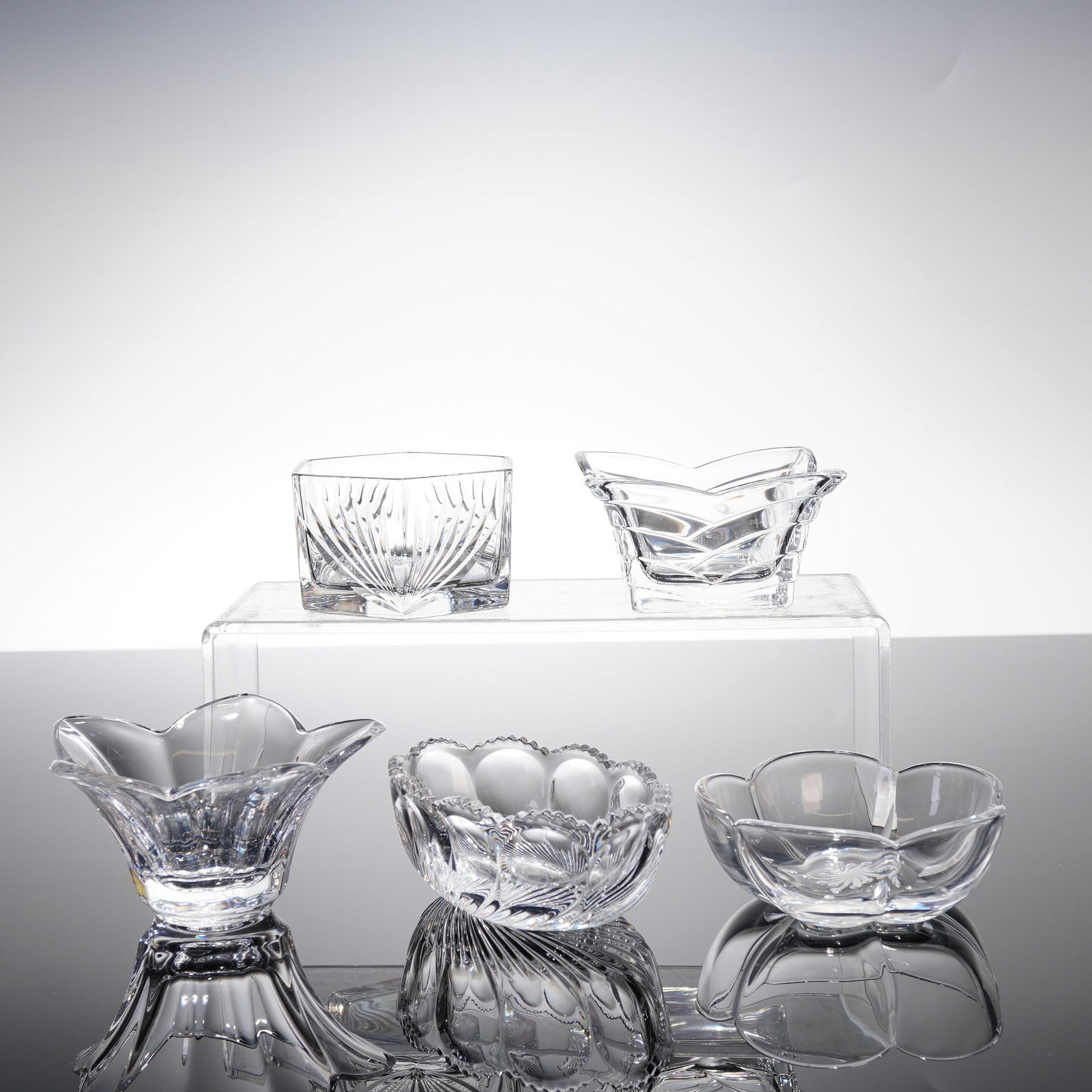 Five Oneida Southern Garden Crystal Dishes with Storage Box: A collection of five small cut crystal serving dishes attributed to the Oneida Southern Garden pattern, accompanied by their original wooden storage box. The vessels are crafted from clear colorless c