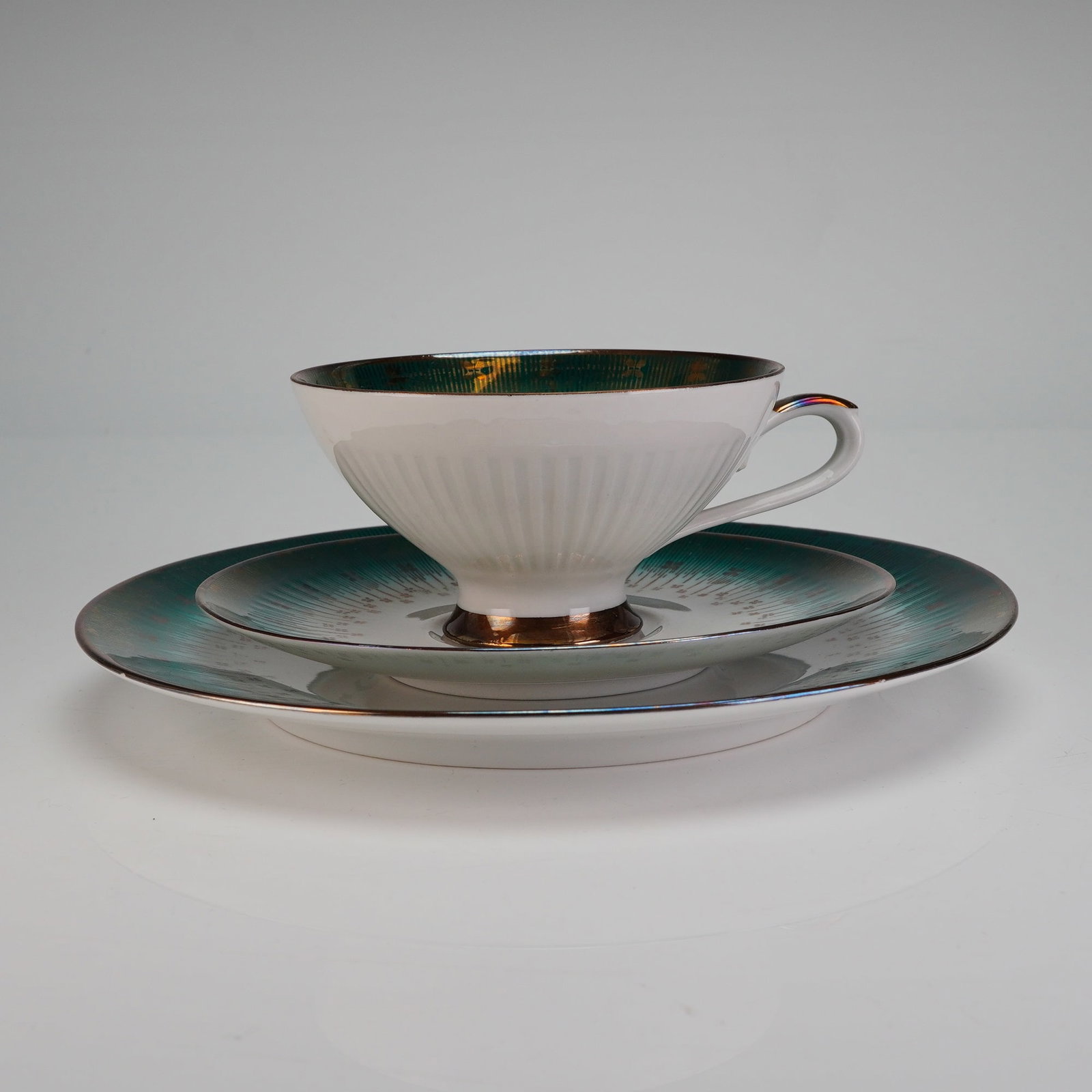 Bareuther Waldsassen Bavaria Trio Tea Set, Emerald Gold: This trio set is decorated in a striking Mid-Century Modern style. The white porcelain body is adorned with a lustrous, iridescent emerald, green band overlaid with an intricate radial gold starburst