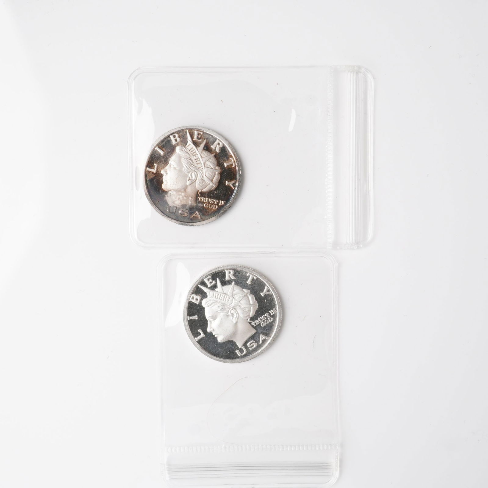 2pc 2003 1/2 Troy Ounce Five Dollar Silver Rounds: A lot comprising two privately issued Liberty Dollar silver rounds, each denominated at five dollars and struck in .999 fine silver. The obverse portrays a diademed bust of Liberty facing left, with i