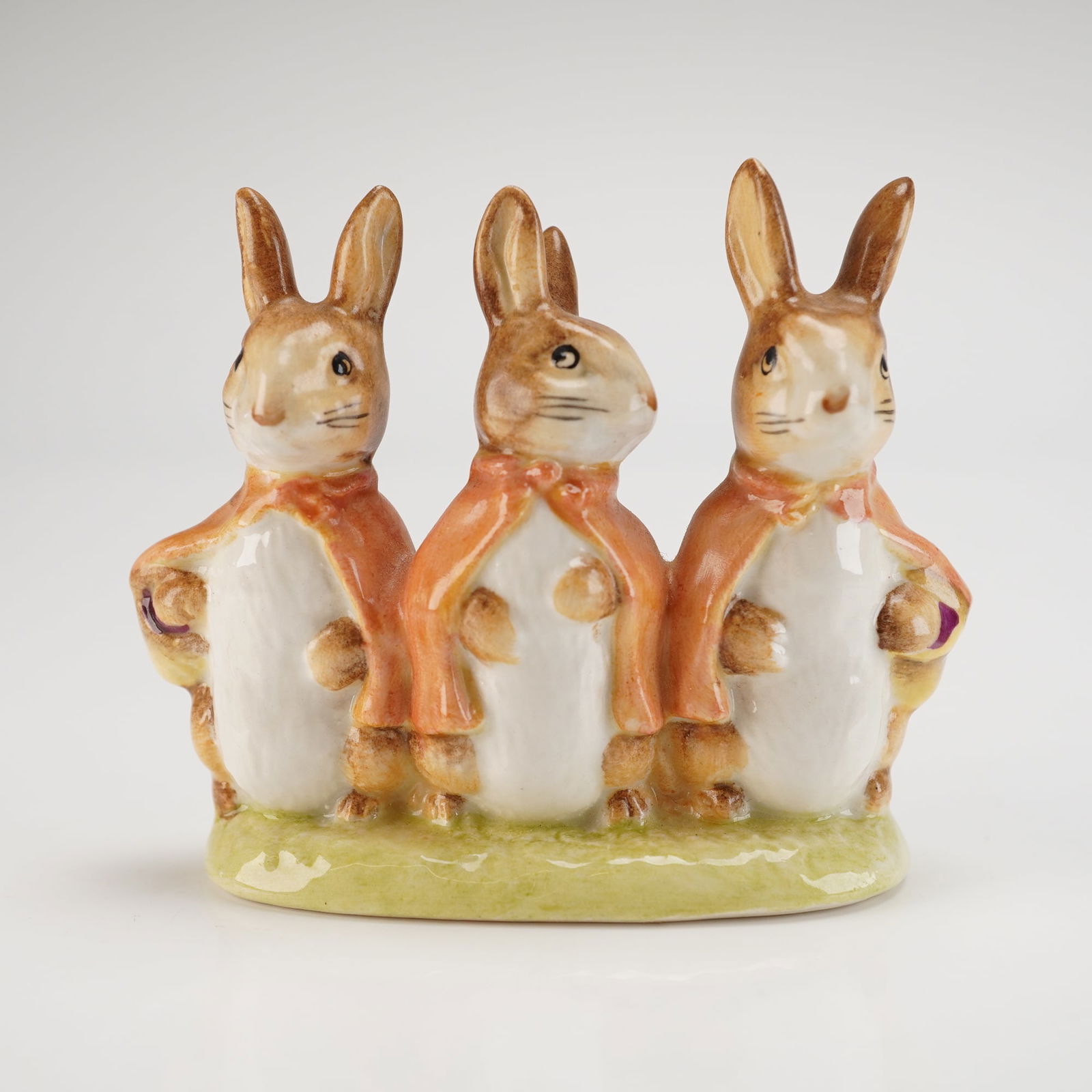 Beswick Beatrix Potter's Figurine, Flopsy, Mopsy and Cottontail: Model number P1274, depicting the Beatrix Potter characters Flopsy, Mopsy, and Cottontail. The piece is crafted from glossy glazed porcelain and hand-painted. The three rabbits are modeled standing si