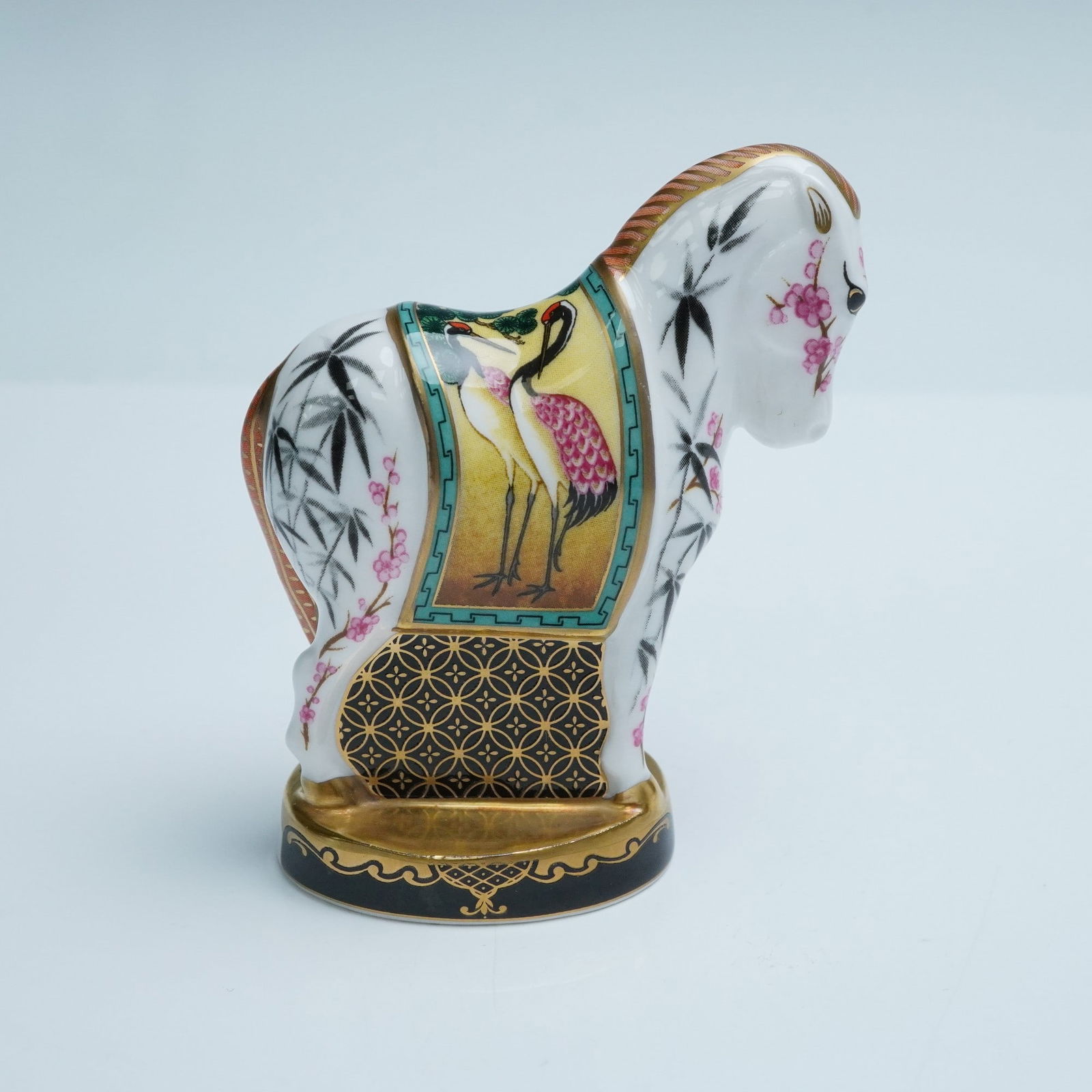 Royal Worcester Porcelain Candle Snuffer, Chinese Year of The Horse: This distinctive figure commemorates the "Chinese Year of the Horse" as part of the Connoisseur Collection. The form, rendered with stylized elegance, features a standing horse adorned with intricate